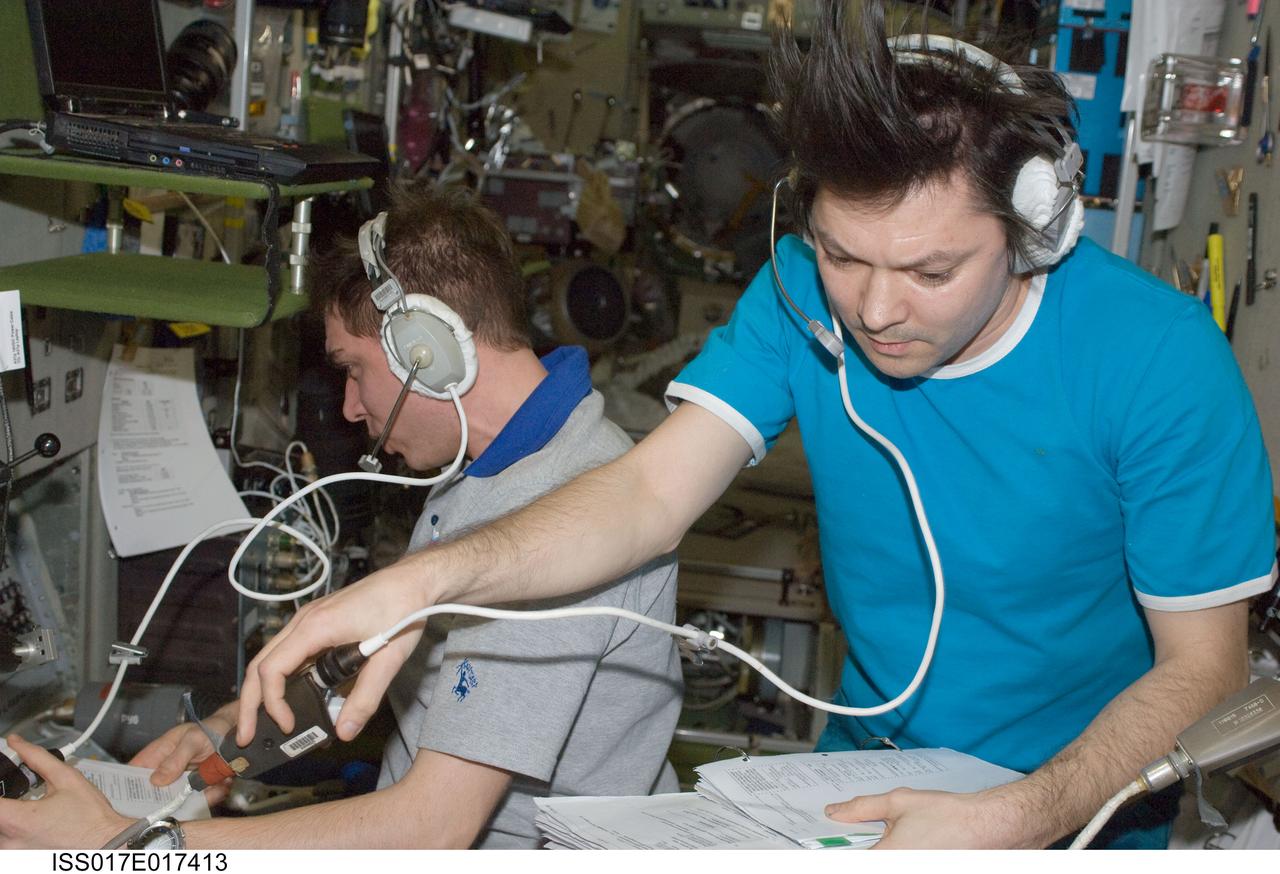 ISS017-E-017413 (17 Sept. 2008) --- Russian Federal Space Agency cosmonauts Sergei Volkov (left) and Oleg Kononenko, Expedition 17 commander and flight engineer, respectively, monitor data at the manual TORU docking system controls in the Zvezda Service Module of the International Space Station during the docking of the unpiloted Progress 30 supply vehicle. The Progress used the automated Kurs system to dock to Zvezda's aft port on Sept. 17.