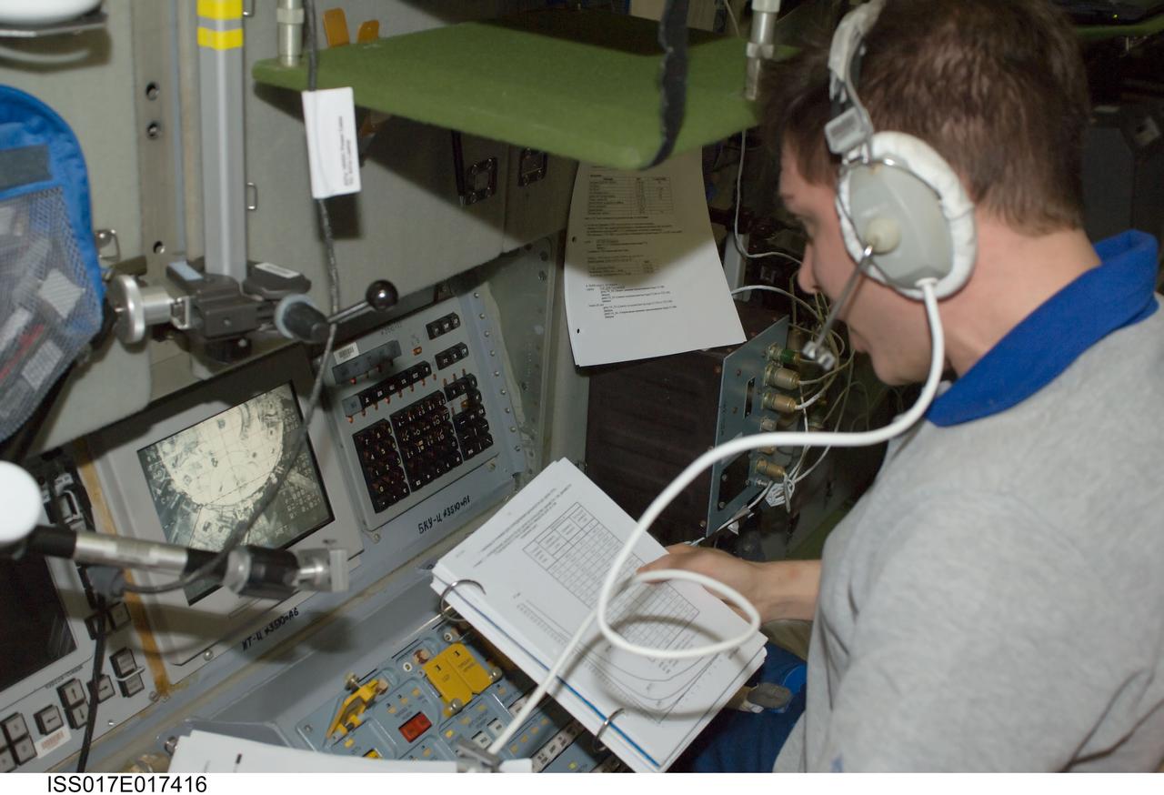 ISS017-E-017416 (17 Sept. 2008) --- Russian Federal Space Agency cosmonaut Sergei Volkov, Expedition 17 commander, monitors data at the manual TORU docking system controls in the Zvezda Service Module of the International Space Station during the docking of the unpiloted Progress 30 supply vehicle. The Progress used the automated Kurs system to dock to Zvezda's aft port on Sept. 17.