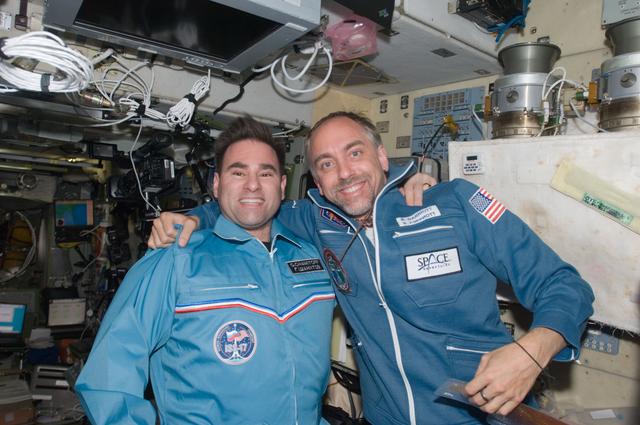 NASA image: Chamitoff and Garriott pose for photo in the SM during Joint Operations