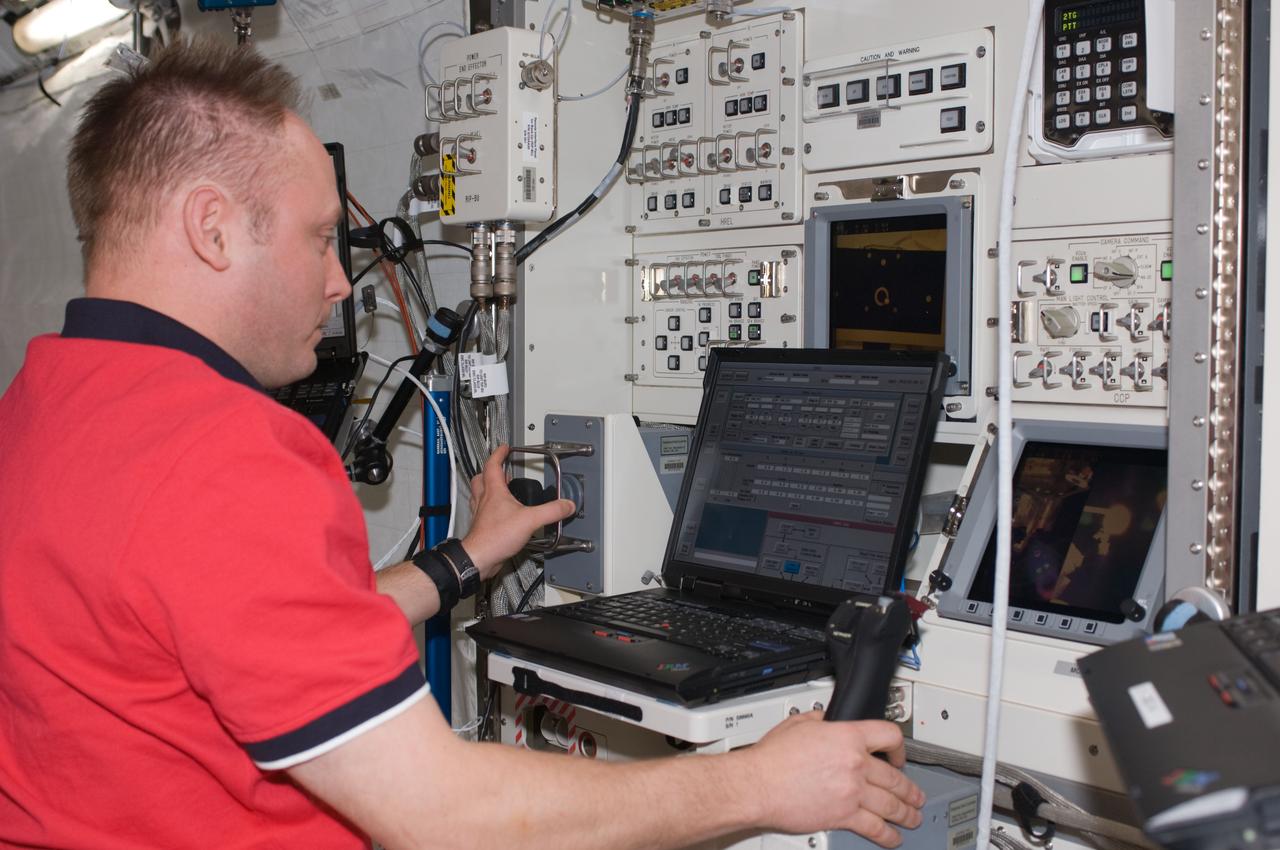 ISS017-E-019979 (19 Oct. 2008) --- NASA astronaut Michael Fincke, Expedition 18 commander, activates the Robotics Laptop Terminal (RLT) of the JEM Robotic Manipulator System (JEMRMS) in the Kibo laboratory of the International Space Station.