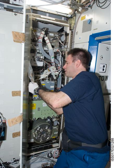 NASA image: Chamitoff works with the H2 Sensor in the  U.S. Laboratory during Joint Operations