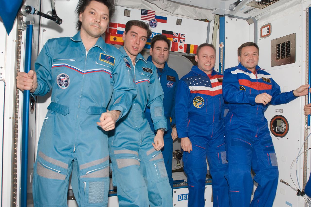 ISS017-E-021343 (22 Oct. 2008) --- Crewmembers aboard the International Space Station pose for a group portrait during the ceremony of Changing-of-Command from Expedition 17 to Expedition 18 in the Harmony node. From the left are cosmonauts Oleg Kononenko and Sergei Volkov, Expedition 17 flight engineer and commander, respectively; astronaut Greg Chamitoff, Expedition 18 flight engineer; astronaut Michael Fincke and cosmonaut Yury Lonchakov, Expedition 18 commander and flight engineer, respectively.