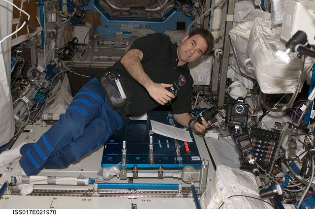 NASA image: Chamitoff works with camera equipment in the U.S. Laboratory during Expedition 18