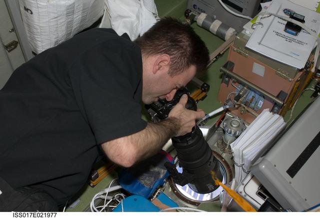 NASA image: Chamitoff uses still camera in the SM during Joint Operations