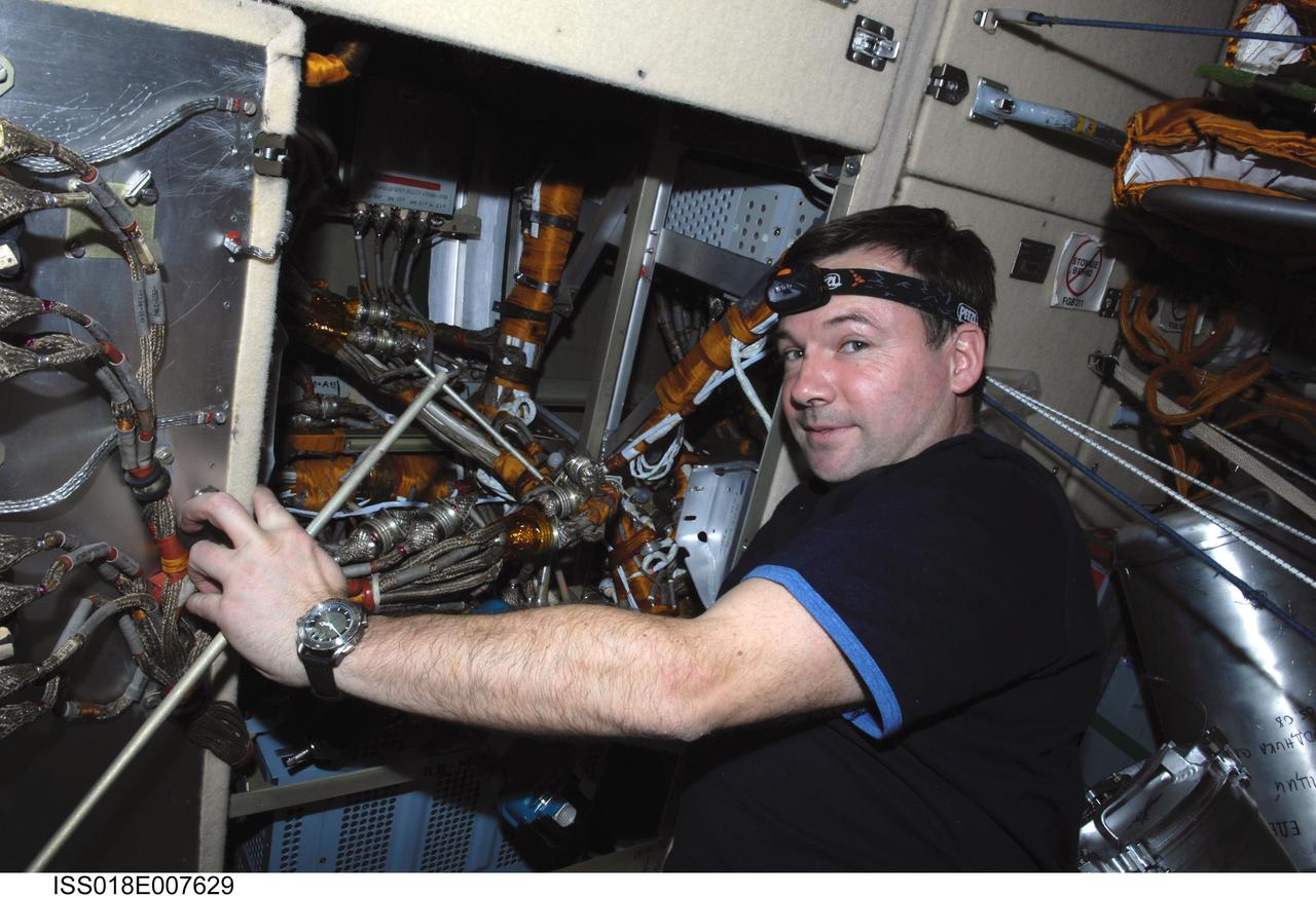 ISS018-E-007629 (7 Nov. 2008) --- Cosmonaut Yury Lonchakov, Expedition 18 flight engineer, takes a moment for a photo while performing in-flight maintenance on the Komparus A3 System in the Zarya module of the International Space Station.