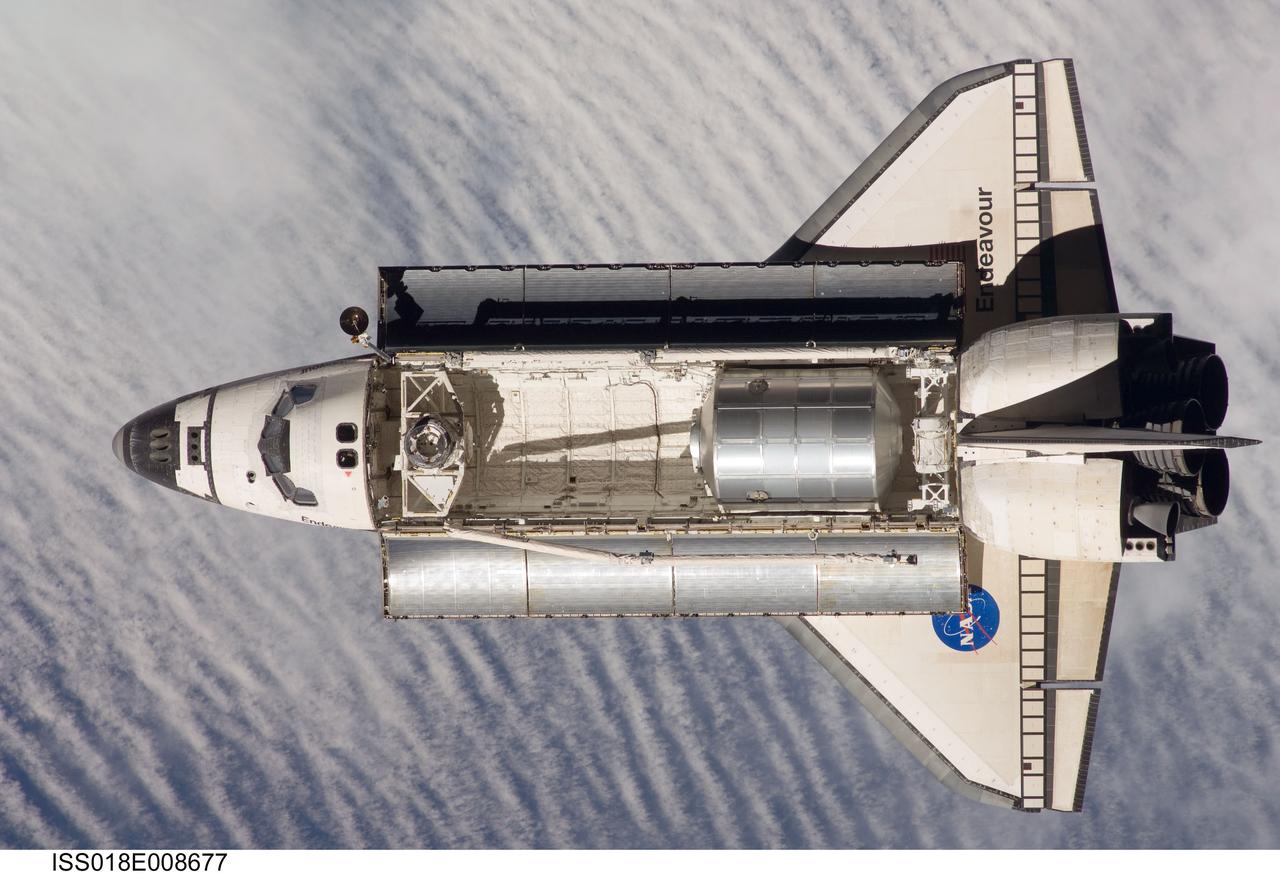 ISS018-E-008677 (16 Nov. 2008) --- Backdropped by a cloud-covered part of Earth, Space Shuttle Endeavour approaches the International Space Station during STS-126 rendezvous and docking operations. Docking occurred at 4:01 p.m. (CST) on Nov. 16, 2008. The Leonardo Multi-Purpose Logistics Module is visible in Endeavour's cargo bay with over 14,000 pounds of cargo for the space station.