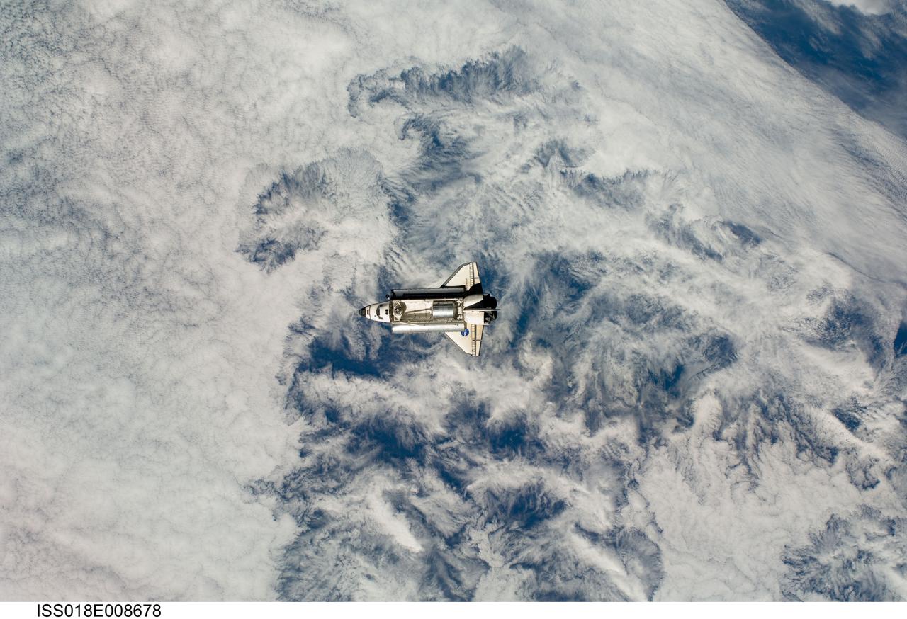 ISS018-E-008678 (16 Nov. 2008) --- Backdropped by a cloud-covered part of Earth, Space Shuttle Endeavour approaches the International Space Station during STS-126 rendezvous and docking operations. Docking occurred at 4:01 p.m. (CST) on Nov. 16, 2008. The Leonardo Multi-Purpose Logistics Module is visible in Endeavour's cargo bay with over 14,000 pounds of cargo for the space station.
