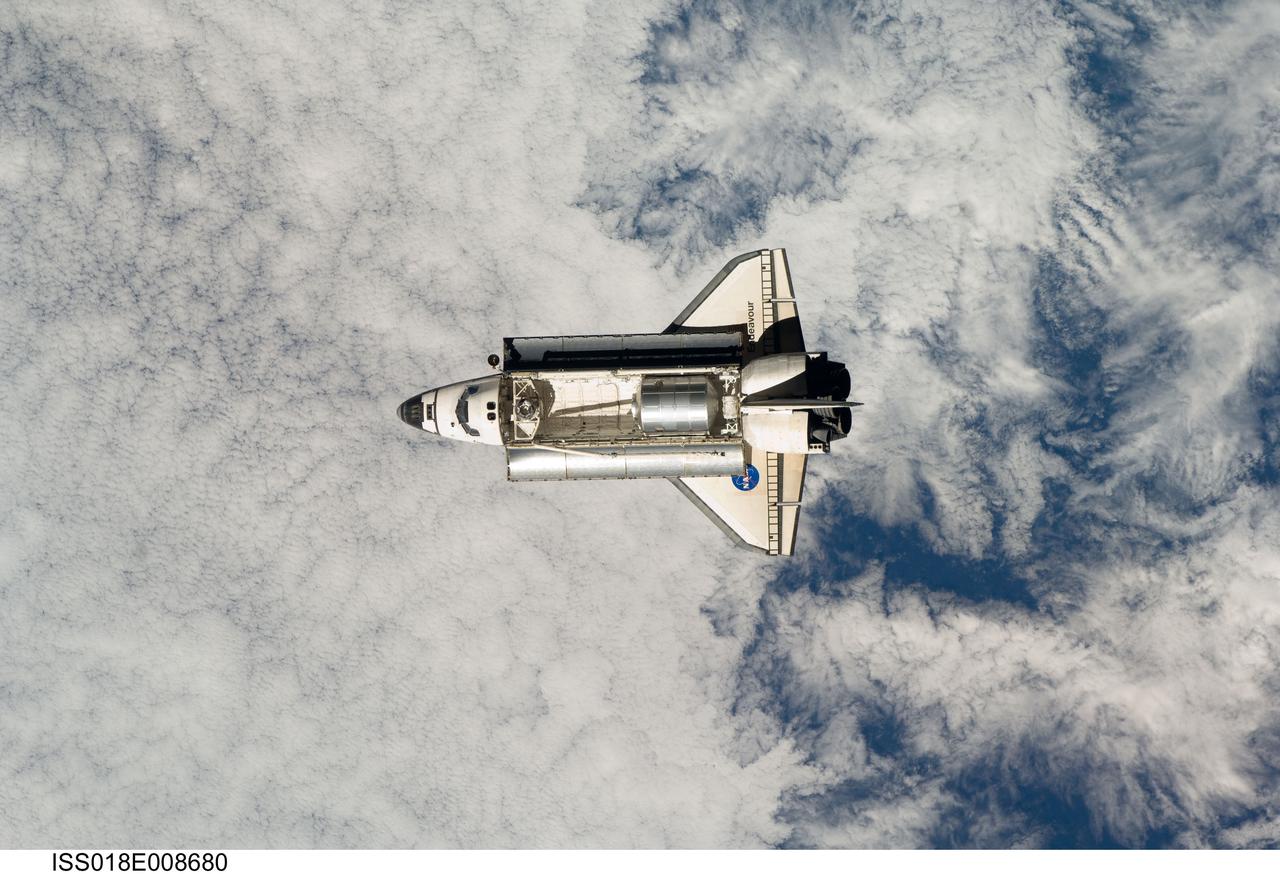 ISS018-E-008680 (16 Nov. 2008) --- Backdropped by a cloud-covered part of Earth, Space Shuttle Endeavour approaches the International Space Station during STS-126 rendezvous and docking operations. Docking occurred at 4:01 p.m. (CST) on Nov. 16, 2008. The Leonardo Multi-Purpose Logistics Module is visible in Endeavour's cargo bay with over 14,000 pounds of cargo for the space station.