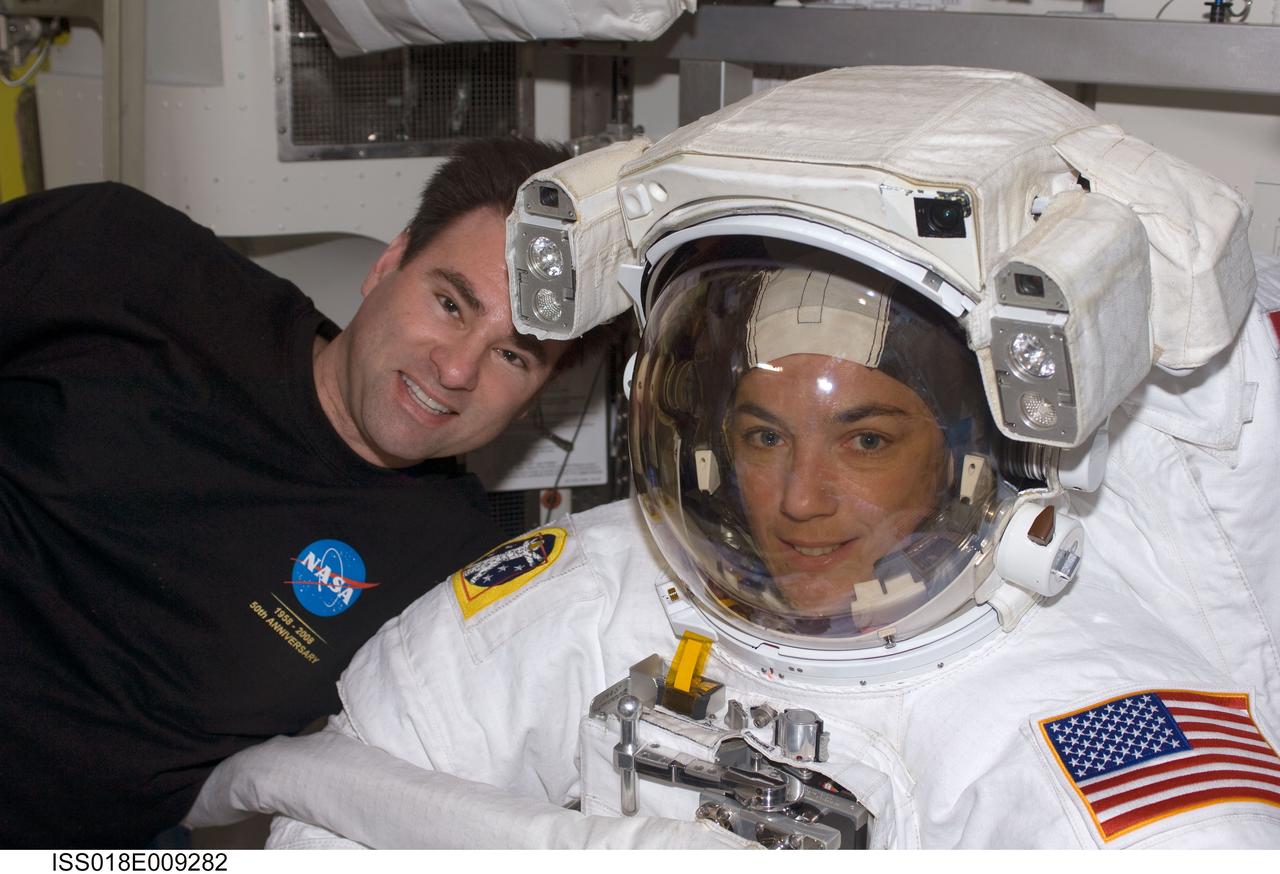 ISS018-E-009282 (18 Nov. 2008) --- Astronauts Heidemarie Stefanyshyn-Piper (right) and Greg Chamitoff, both STS-126 mission specialists, take a moment for a photo during preparations for the mission's first scheduled session of extravehicular activity (EVA) in the Quest Airlock of the International Space Station. Piper is attired in her Extravehicular Mobility Unit (EMU) spacesuit.