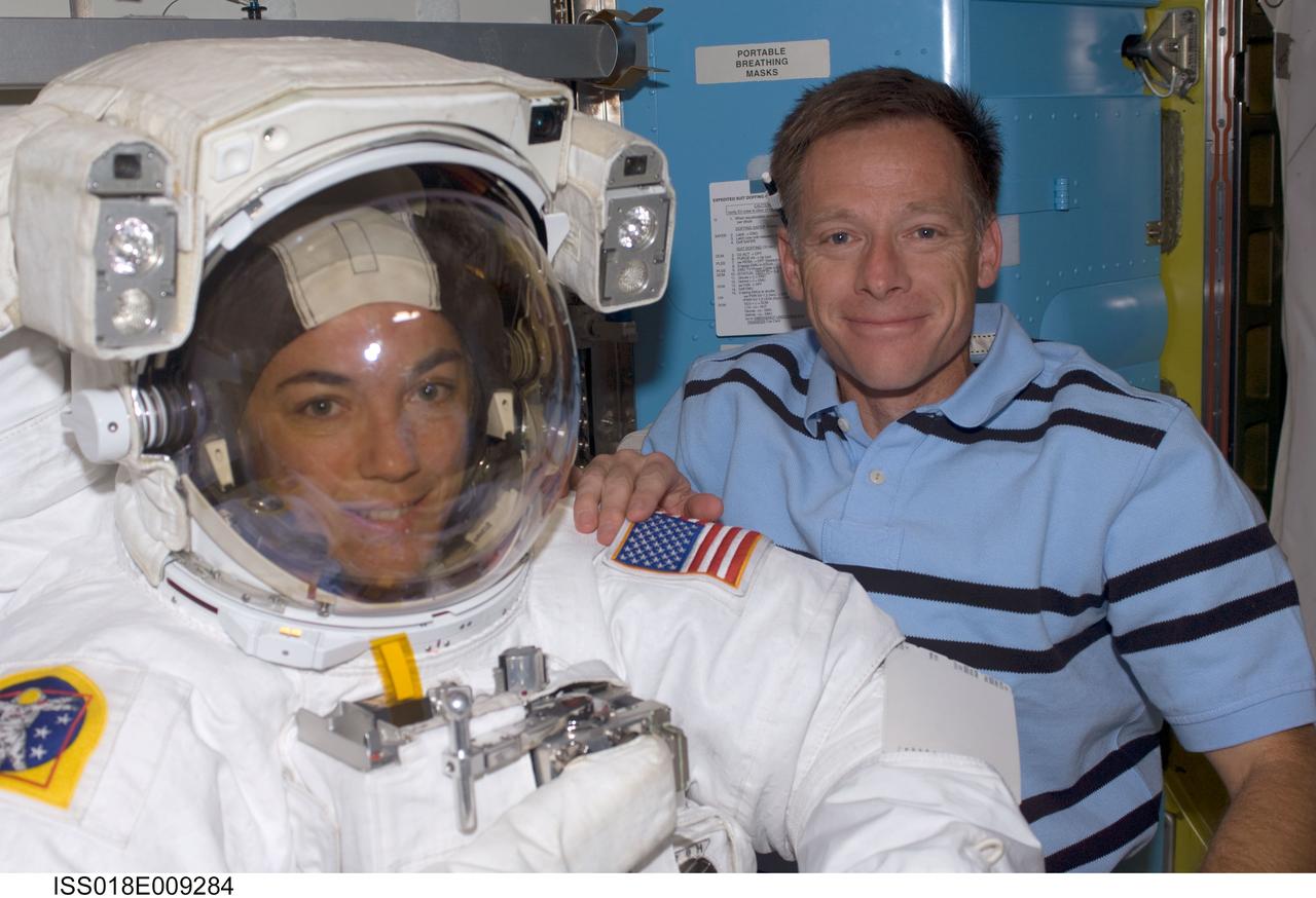 ISS018-E-009284 (18 Nov. 2008) --- Astronauts Chris Ferguson, STS-126 commander, and Heidemarie Stefanyshyn-Piper, mission specialist, take a moment for a photo during preparations for the mission's first scheduled session of extravehicular activity (EVA) in the Quest Airlock of the International Space Station. Piper is attired in her Extravehicular Mobility Unit (EMU) spacesuit.