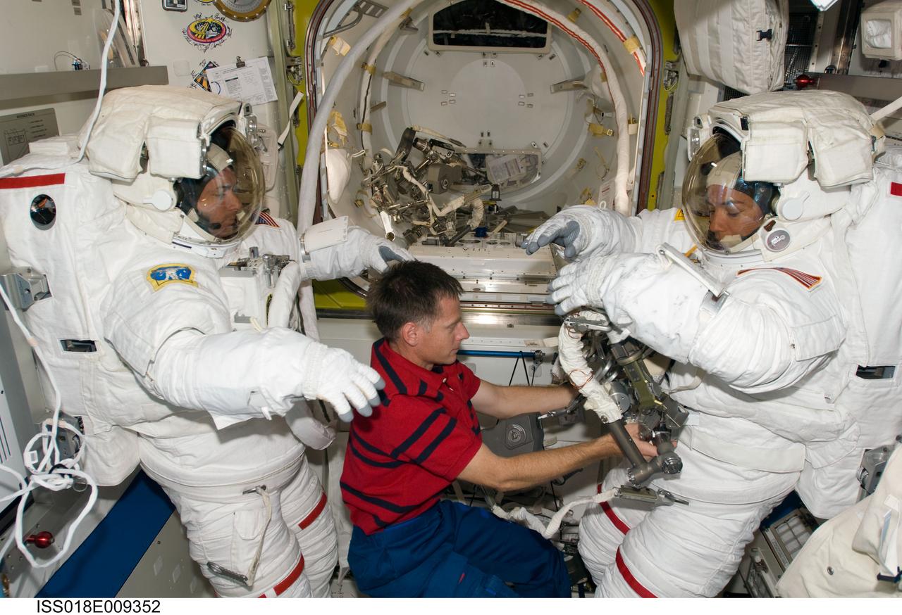 ISS018-E-009352 (20 Nov. 2008) --- Astronauts Shane Kimbrough (left) and Heidemarie Stefanyshyn-Piper, both STS-126 mission specialists, attired in their Extravehicular Mobility Unit (EMU) spacesuit, prepare for the mission's second scheduled session of extravehicular activity (EVA) in the Quest Airlock of the International Space Station. Astronaut Chris Ferguson, commander, assisted Kimbrough and Piper.