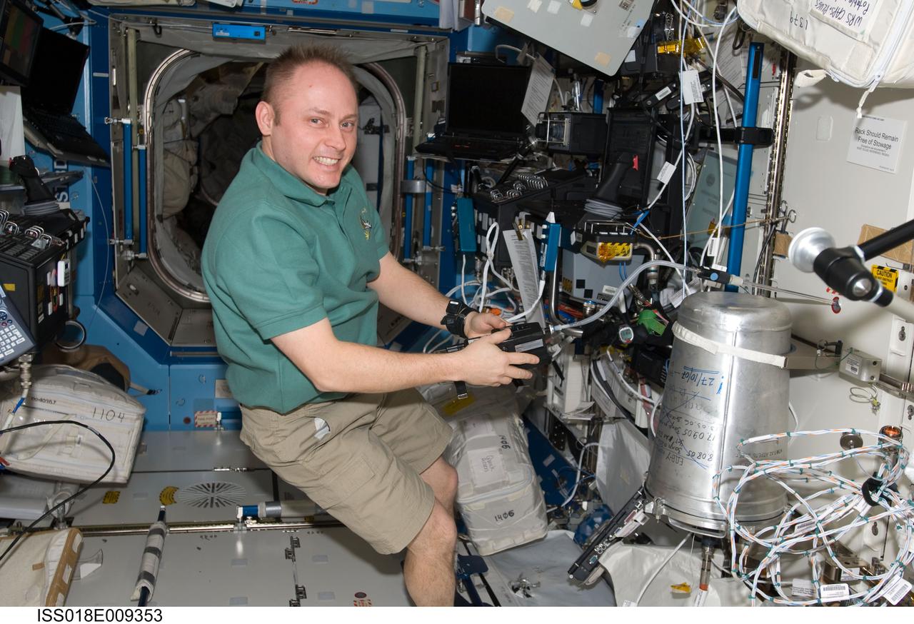 ISS018-E-009353 (20 Nov. 2008) --- Astronaut Michael Fincke, Expedition 18 commander, works in the Destiny laboratory of the International Space Station while Space Shuttle Endeavour (STS-126) remains docked with the station.
