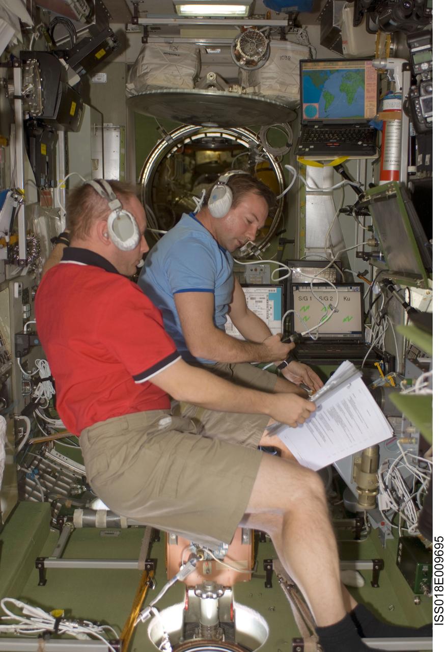 ISS018-E-009695 (30 Nov. 2008) --- Astronaut Michael Fincke (foreground), Expedition 18 commander; and cosmonaut Yury Lonchakov, flight engineer, monitor the approach of the Progress 31 supply vehicle at the manual TORU docking system controls in the Zvezda Service Module of the International Space Station. Progress 31 docked to the Pirs Docking Compartment at 6:28 a.m. (CST) on Nov. 30, after a four day flight from Baikonur Cosmodrome in Kazakhstan. Lonchakov used the TORU system to bring the Progress to its docking port.