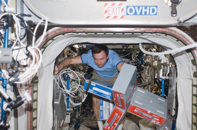 NASA image: ISS Expedition 18 Yuri Lonchakov carries boxes through Destiny Laboratory