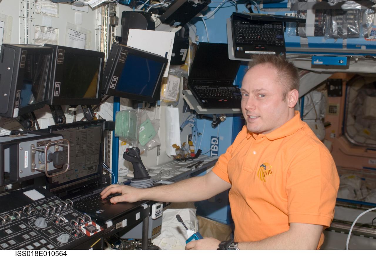 ISS018-E-010564 (5 Dec. 2008) --- Astronaut Michael Fincke, Expedition 18 commander, uses a computer at the robotics work station in the Destiny laboratory of the International Space Station. Using the station's robotic arm, Fincke and astronaut Sandra Magnus (out of frame), flight engineer, relocated the ESP-3 from the Mobile Base System back to the Cargo Carrier Attachment System on the P3 truss. The ESP-3 spare parts platform was temporarily parked on the MBS to clear the path for the spacewalks during STS-126.