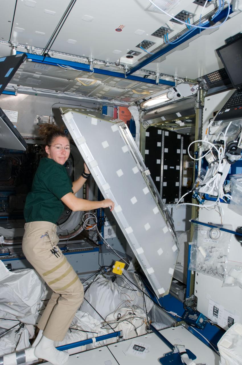 ISS018-E-013808 (18 Dec. 2008) --- Astronaut Sandra Magnus, Expedition 18 flight engineer, works on a crew quarters compartment in the Harmony node of the International Space Station.