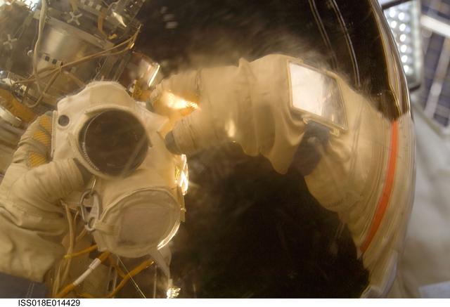 NASA image: Visor reflection self portrait during Russian Extravehicular Activity (EVA) 21