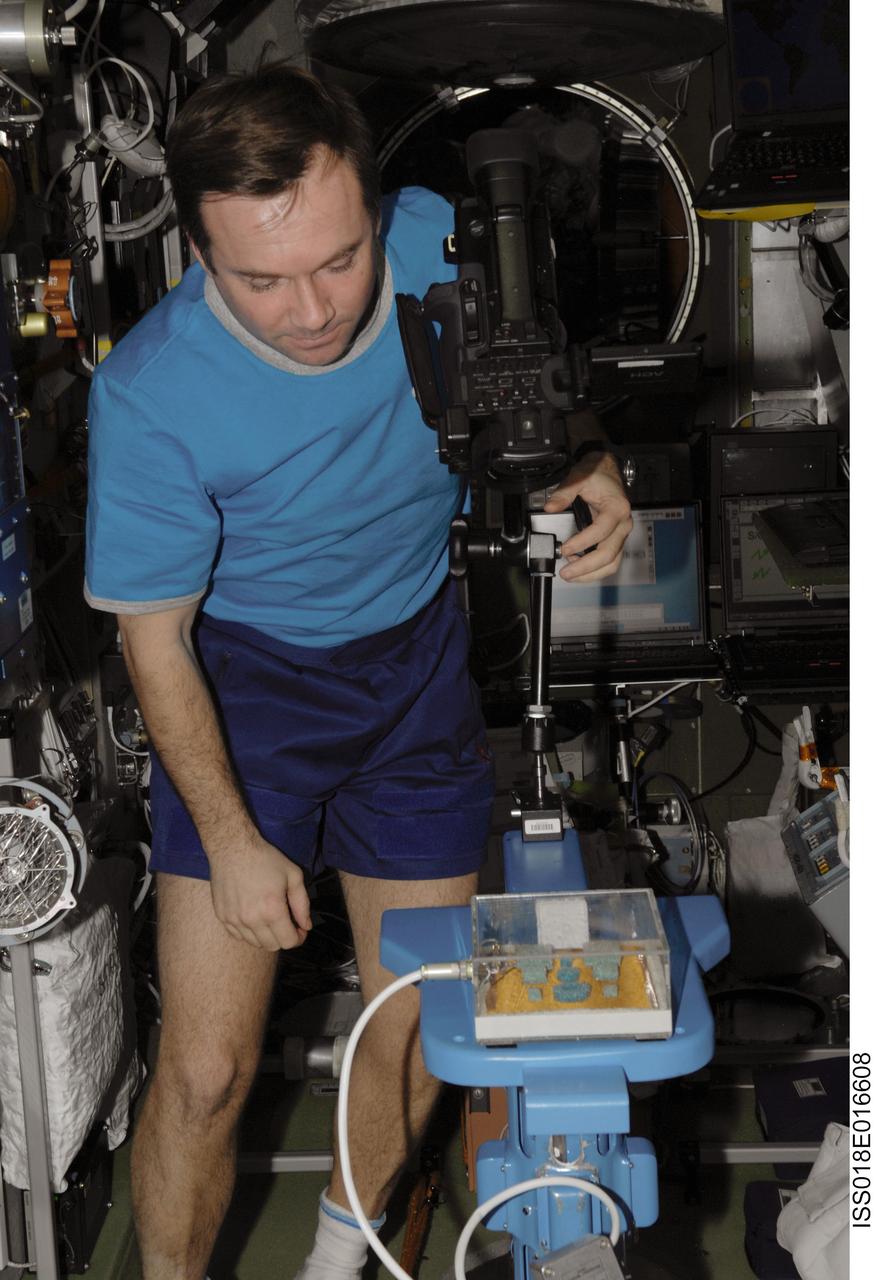 ISS018-E-016608 (5 Jan. 2009) --- Cosmonaut Yury Lonchakov, Expedition 18 flight engineer, configures a video camera for the MATI-75 experiment in the Zvezda Service Module of the International Space Station.