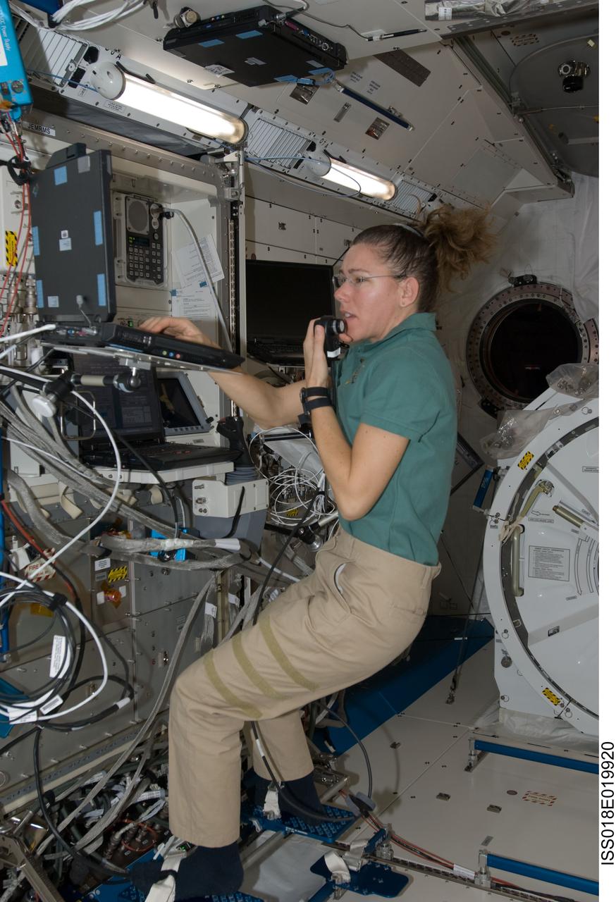 ISS018-E-019920 (19 Jan. 2009) --- Astronaut Sandra Magnus, Expedition 18 flight engineer, uses a communication system while performing a function test of the Japanese Remote Manipulator System (JEM-RMS) in the Kibo laboratory of the International Space Station.
