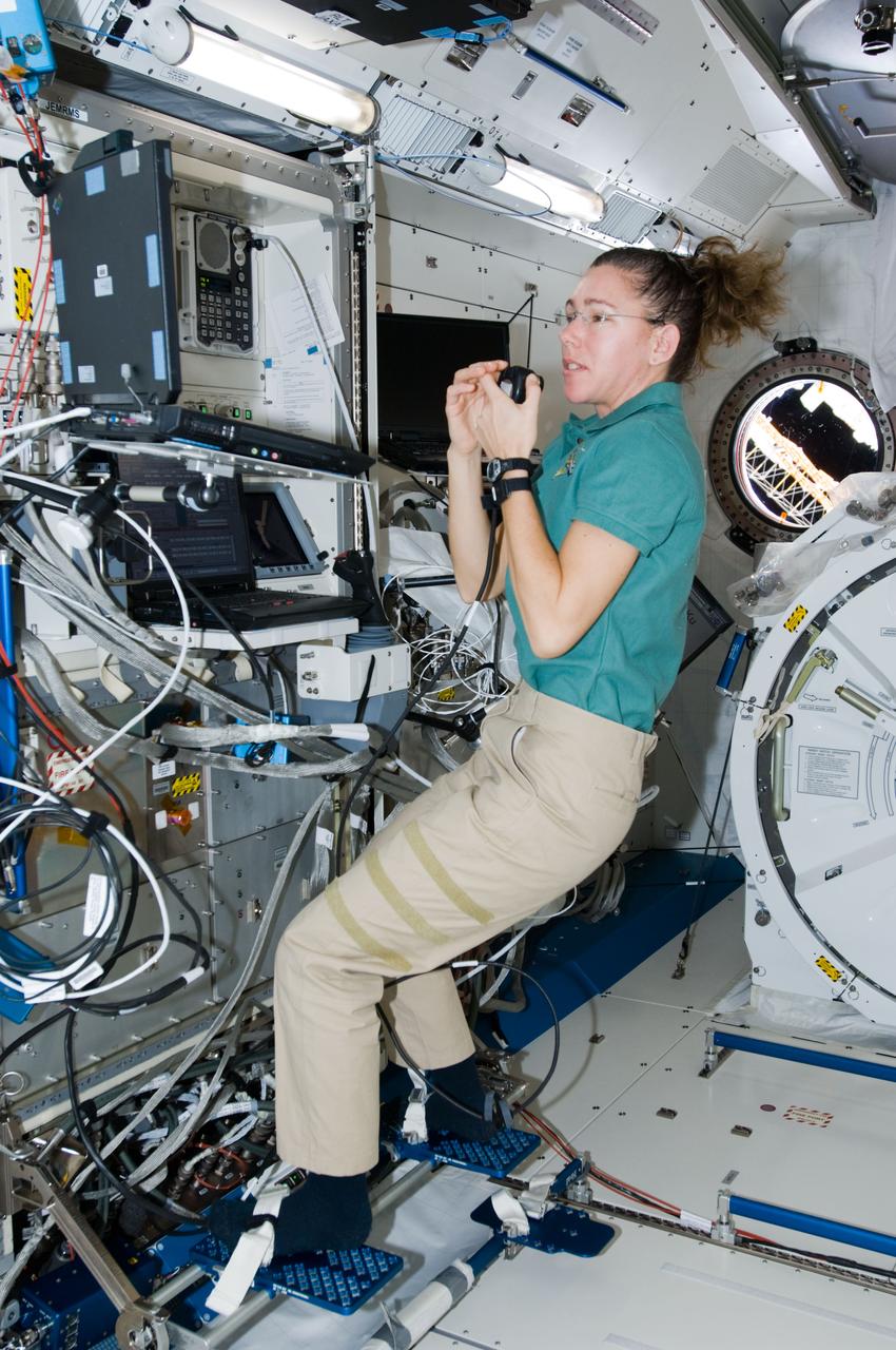 ISS018-E-019933 (19 Jan. 2009) --- Astronaut Sandra Magnus, Expedition 18 flight engineer, uses a communication system while performing a function test of the Japanese Remote Manipulator System (JEM-RMS) in the Kibo laboratory of the International Space Station.