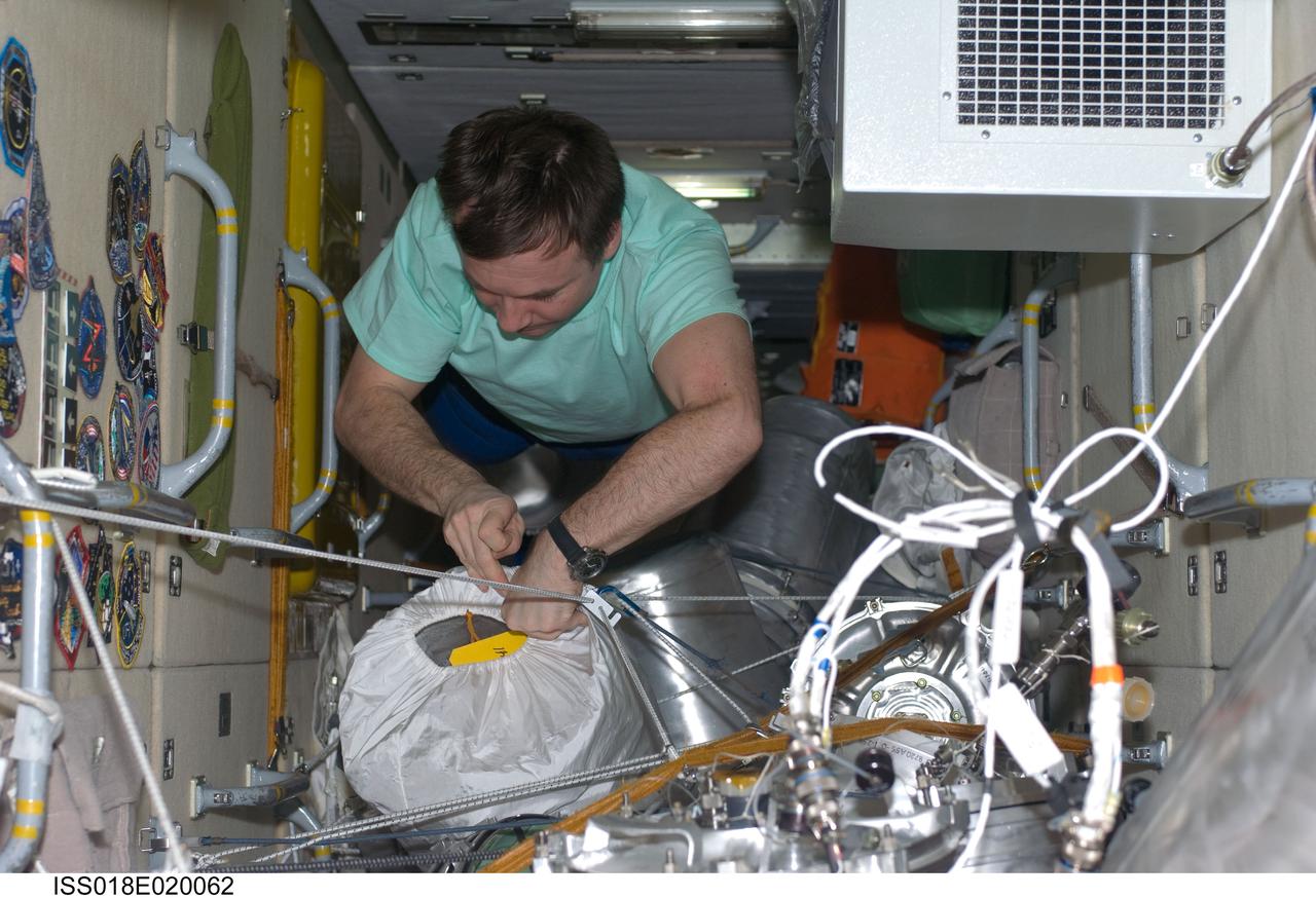 ISS018-E-020062 (14 Jan. 2009) --- Cosmonaut Yury Lonchakov, Expedition 18 flight engineer, works with supplies and equipment stowed in the functional cargo block (FGB) or Zarya of the International Space Station.