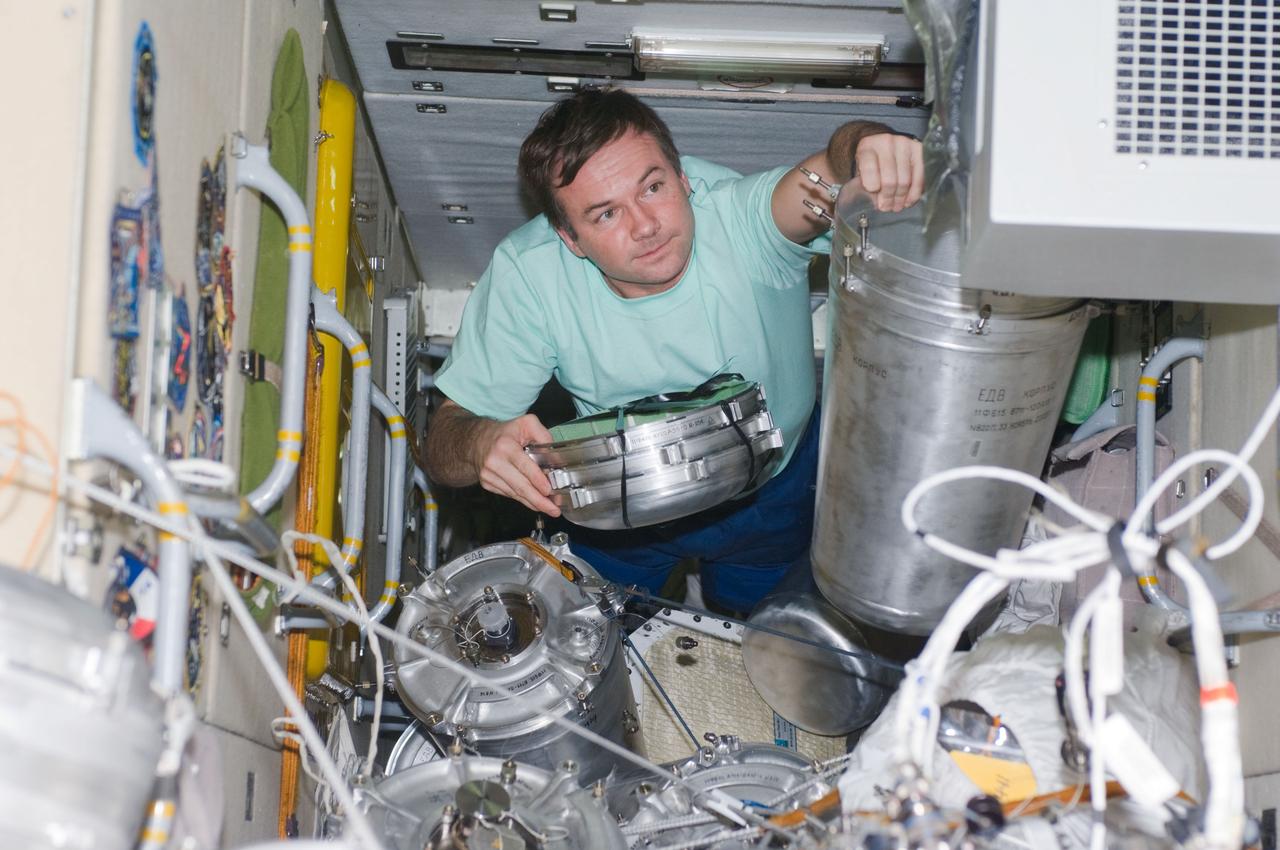 ISS018-E-020075 (14 Jan. 2009) --- Cosmonaut Yury Lonchakov, Expedition 18 flight engineer, works with supplies and equipment stowed in the functional cargo block (FGB) or Zarya of the International Space Station.