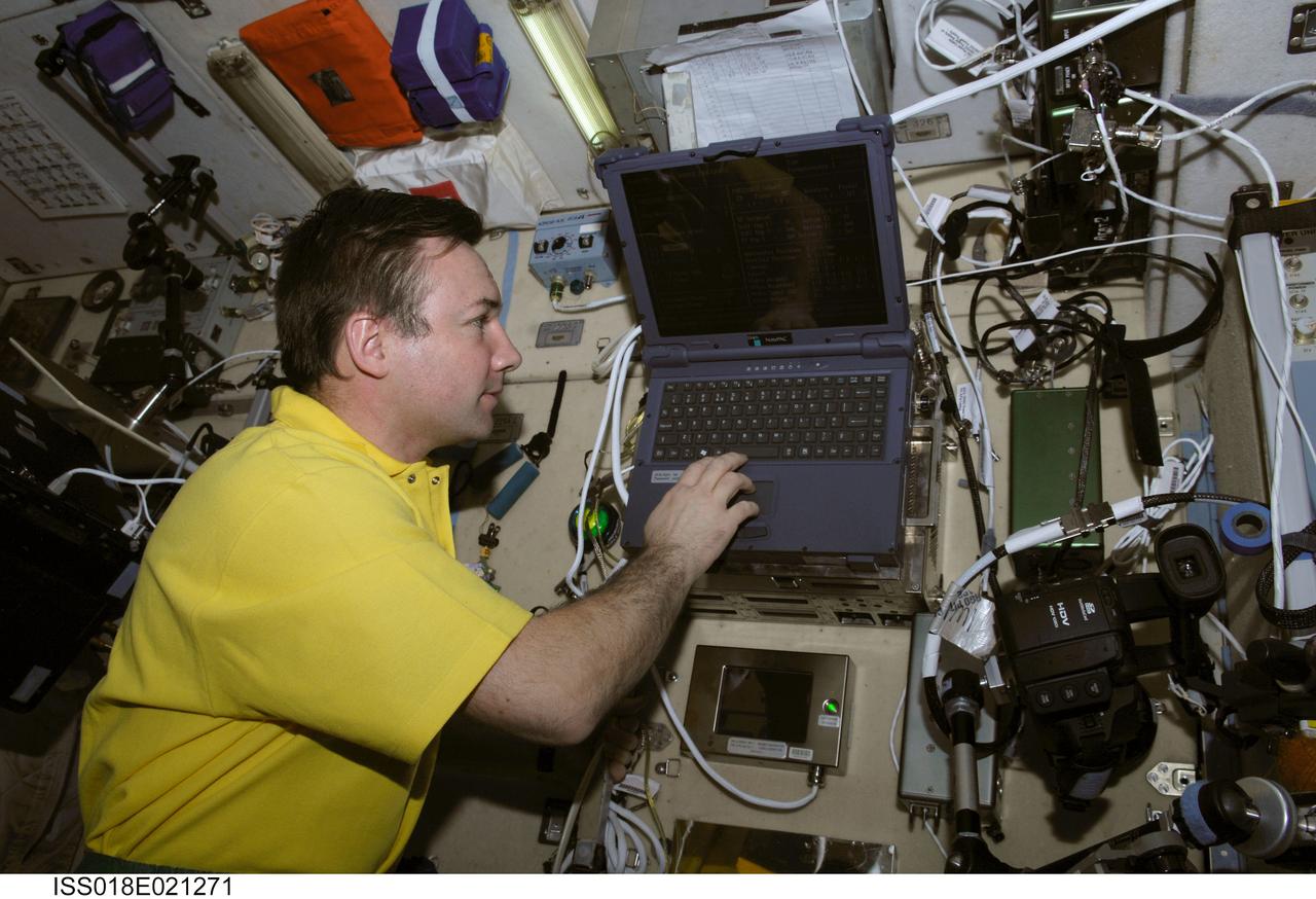 ISS018-E-021271 (23 Jan. 2009) --- Cosmonaut Yury Lonchakov, Expedition 18 flight engineer, uses a computer in the Zvezda Service Module of the International Space Station.