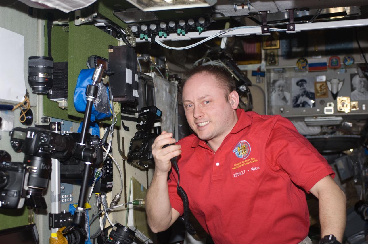 ISS018-E-023674 (27 Jan. 2009) --- Astronaut Michael Fincke, Expedition 18 commander, uses a ham radio system in the Zvezda Service Module of the International Space Station.