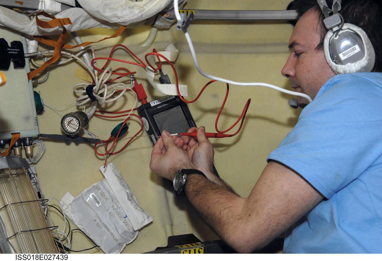 ISS018-E-027439 (6 Feb. 2009) --- Cosmonaut Yury Lonchakov, Expedition 18 flight engineer, uses an oscilloscope to measure voltage in the Pirs Docking Compartment of the International Space Station.