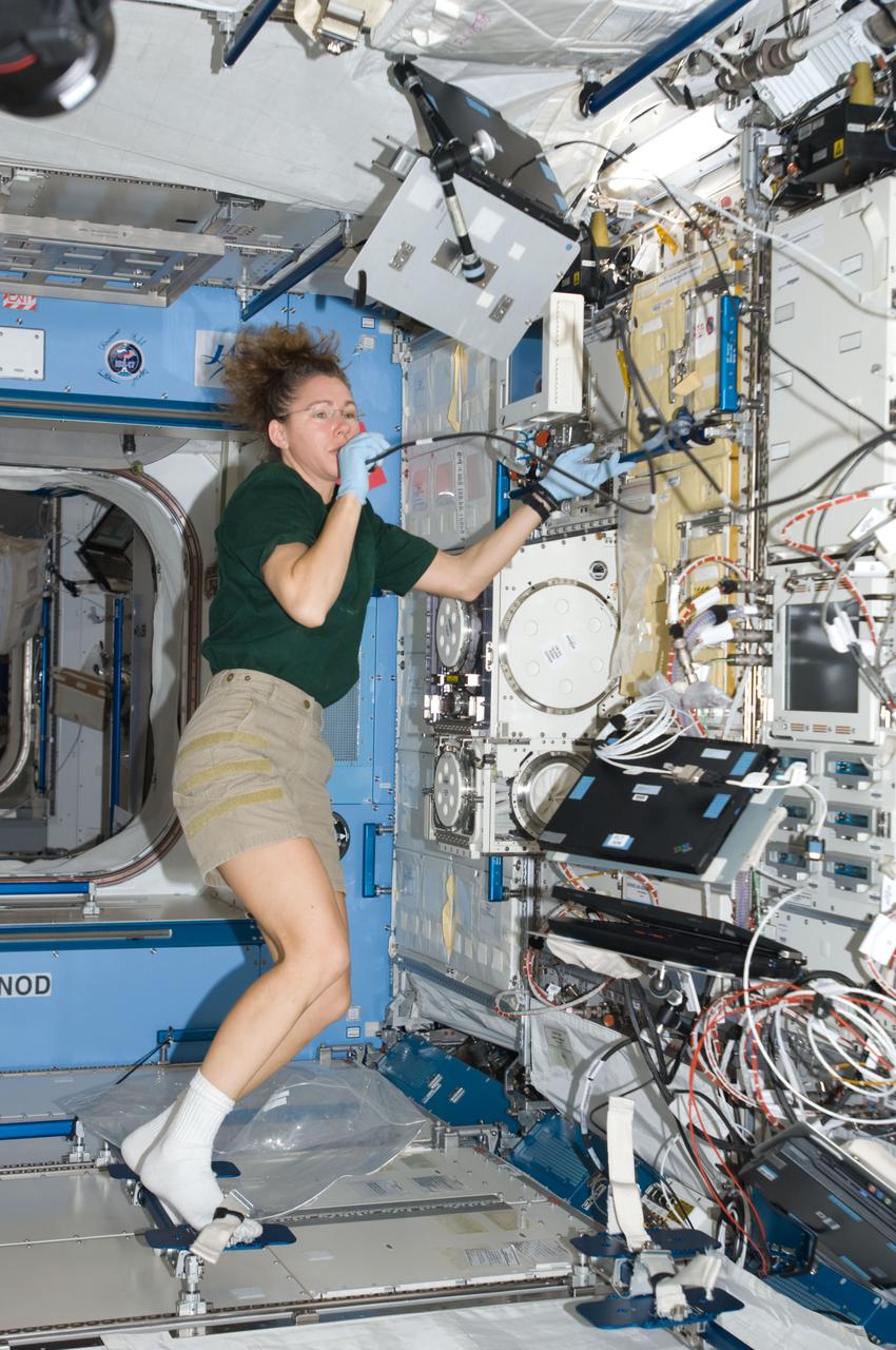 ISS018-E-034090 (20 Feb. 2009) --- Astronaut Sandra Magnus, Expedition 18 flight engineer, uses a communication system near the Cell Biology Experiment Facility (CBEF) in the Kibo laboratory of the International Space Station.