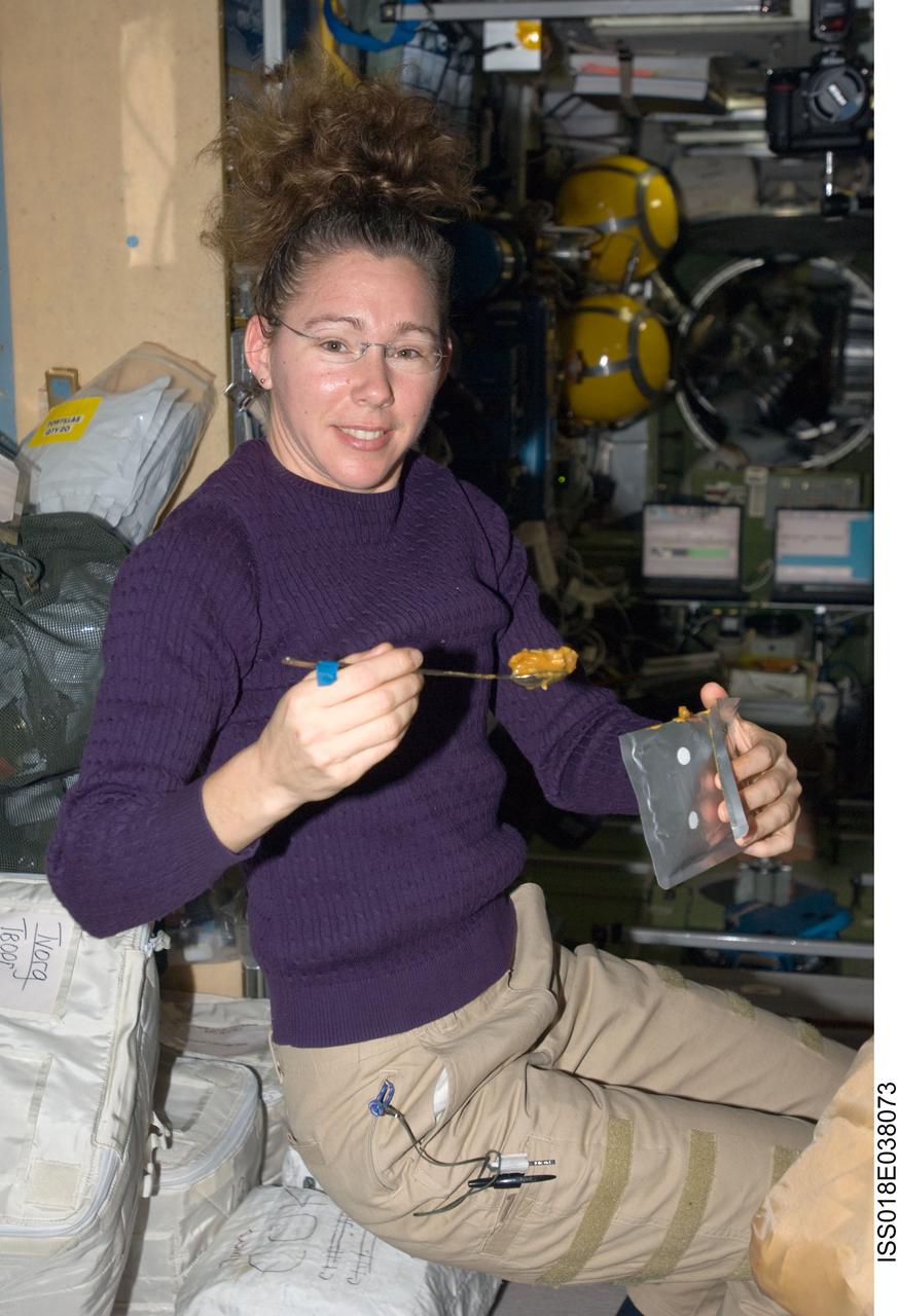 ISS018-E-038073 (4 March 2009) --- Astronaut Sandra Magnus, Expedition 18 flight engineer, eats a meal in the Zvezda Service Module of the International Space Station.