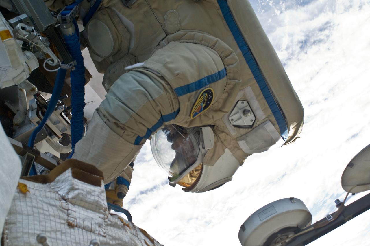 ISS018-E-039156 (10 March 2009) --- Cosmonaut Yury Lonchakov, Expedition 18 flight engineer, participates in a session of extravehicular activity (EVA) to perform maintenance on the International Space Station. During the 4-hour, 49-minute spacewalk, Lonchakov and astronaut Michael Fincke (out of frame), commander, reinstalled the Exposing Specimens of Organic and Biological Materials to Open Space (Expose-R) experiment on the universal science platform mounted to the exterior of the Zvezda Service Module. The spacewalkers also removed straps, or tape, from the area of the docking target on the Pirs airlock and docking compartment. The tape was removed to ensure it does not get in the way during the arrival of visiting Soyuz or Progress spacecraft.