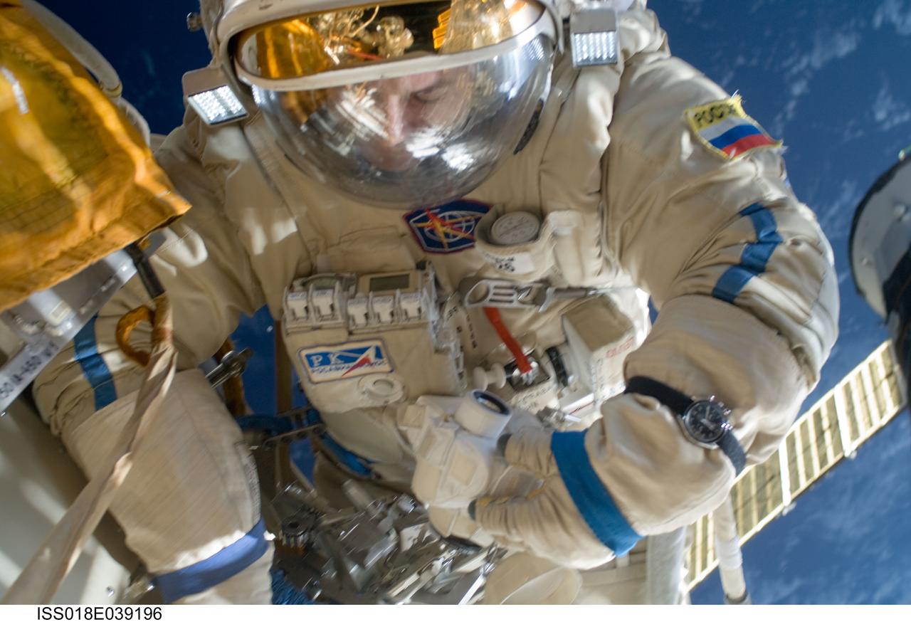 ISS018-E-039196 (10 March 2009) --- Cosmonaut Yury Lonchakov, Expedition 18 flight engineer, participates in a session of extravehicular activity (EVA) to perform maintenance on the International Space Station. During the 4-hour, 49-minute spacewalk, Lonchakov and astronaut Michael Fincke (out of frame), commander, reinstalled the Exposing Specimens of Organic and Biological Materials to Open Space (Expose-R) experiment on the universal science platform mounted to the exterior of the Zvezda Service Module. The spacewalkers also removed straps, or tape, from the area of the docking target on the Pirs airlock and docking compartment. The tape was removed to ensure it does not get in the way during the arrival of visiting Soyuz or Progress spacecraft.