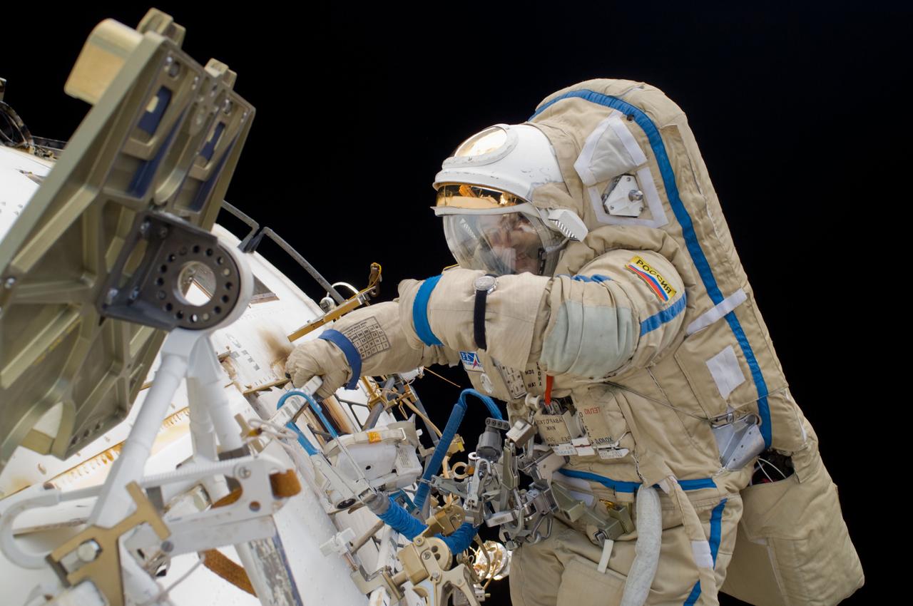 ISS018-E-039239 (10 March 2009) --- Cosmonaut Yury Lonchakov, Expedition 18 flight engineer, participates in a session of extravehicular activity (EVA) to perform maintenance on the International Space Station. During the 4-hour, 49-minute spacewalk, Lonchakov and astronaut Michael Fincke (out of frame), commander, reinstalled the Exposing Specimens of Organic and Biological Materials to Open Space (Expose-R) experiment on the universal science platform mounted to the exterior of the Zvezda Service Module. The spacewalkers also removed straps, or tape, from the area of the docking target on the Pirs airlock and docking compartment. The tape was removed to ensure it does not get in the way during the arrival of visiting Soyuz or Progress spacecraft.