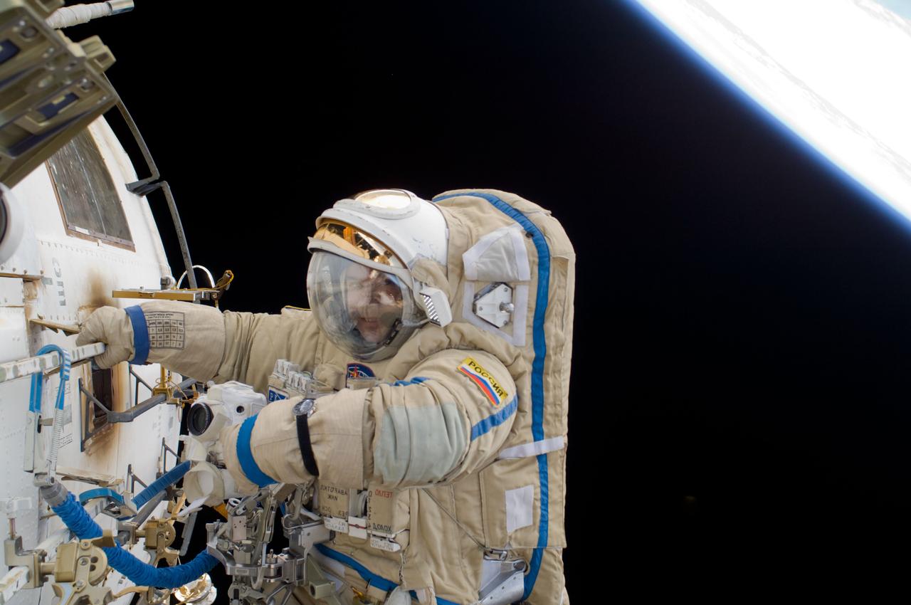 ISS018-E-039241 (10 March 2009) --- Cosmonaut Yury Lonchakov, Expedition 18 flight engineer, participates in a session of extravehicular activity (EVA) to perform maintenance on the International Space Station. During the 4-hour, 49-minute spacewalk, Lonchakov and astronaut Michael Fincke (out of frame), commander, reinstalled the Exposing Specimens of Organic and Biological Materials to Open Space (Expose-R) experiment on the universal science platform mounted to the exterior of the Zvezda Service Module. The spacewalkers also removed straps, or tape, from the area of the docking target on the Pirs airlock and docking compartment. The tape was removed to ensure it does not get in the way during the arrival of visiting Soyuz or Progress spacecraft.