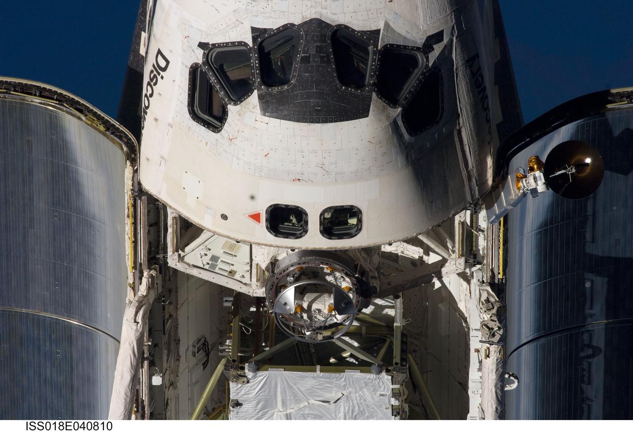 ISS018-E-040810 (17 March 2009) --- An overhead close-up view of the exterior of Space Shuttle Discovery's crew cabin, part of its payload bay and docking system was provided by Expedition 18 crewmembers on the International Space Station. Before docking with the station, astronaut Lee Archambault, STS-119 commander, flew the shuttle through a Rendezvous Pitch Maneuver or basically a backflip to allow the space station crew a good view of Discovery's heat shield. Using digital still cameras equipped with both 400 and 800 millimeter lenses, the ISS crewmembers took a number of photos of the shuttle's thermal protection system and sent them down to teams on the ground for analysis. A 400 millimeter lens was used for this image.