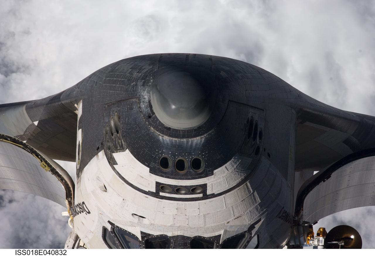 ISS018-E-040832 (17 March 2009) --- A close-up view of the exterior of Space Shuttle Discovery's nose was provided by Expedition 18 crewmembers on the International Space Station. Before docking with the station, astronaut Lee Archambault, STS-119 commander, flew the shuttle through a Rendezvous Pitch Maneuver or basically a backflip to allow the space station crew a good view of Discovery's heat shield. Using digital still cameras equipped with both 400 and 800 millimeter lenses, the ISS crewmembers took a number of photos of the shuttle's thermal protection system and sent them down to teams on the ground for analysis. A 400 millimeter lens was used for this image.