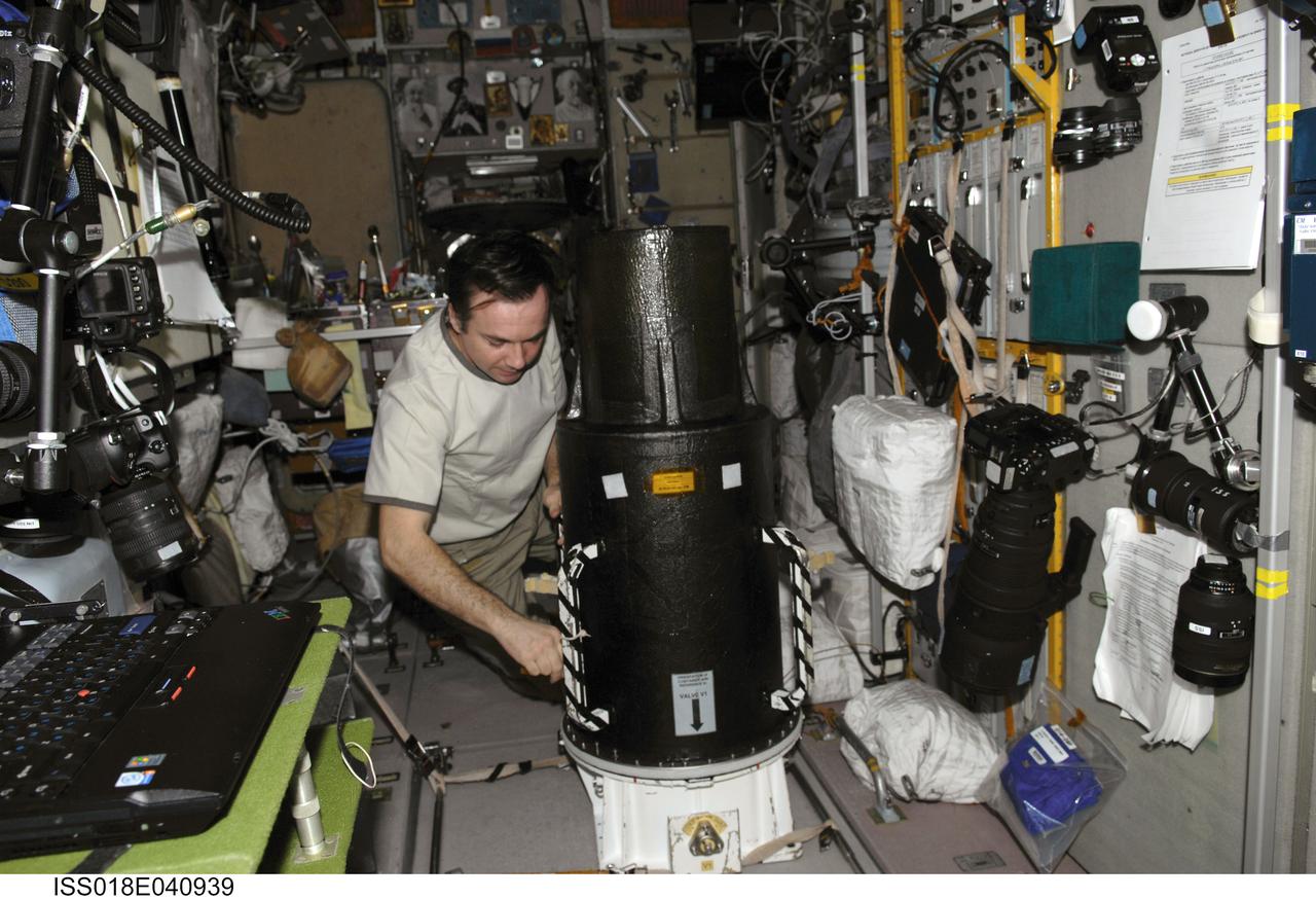 ISS018-E-040939 (18 March 2009) --- Cosmonaut Yury Lonchakov, Expedition 18 flight engineer, prepares to work with the European Matroshka-R Phantom experiment in the Zvezda Service Module of the International Space Station while Space Shuttle Discovery (STS-119) remains docked with the station. Matroshka, the name for the traditional Russian set of nestling dolls, is an antroph-amorphous model of a human torso designed for radiation studies.