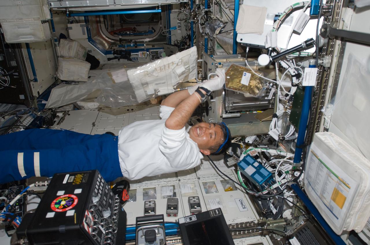 ISS018-E-040949 (18 March 2009) --- Japan Aerospace Exploration Agency (JAXA) astronaut Koichi Wakata, Expedition 18 flight engineer, works in the Destiny laboratory of the International Space Station while Space Shuttle Discovery (STS-119) remains docked with the station.