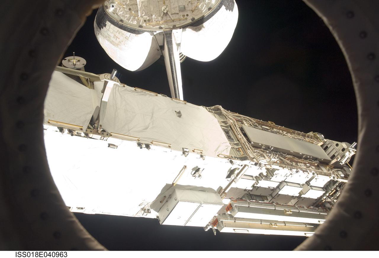 ISS018-E-040963 (18 March 2009) --- This scene of the Space Shuttle Discovery parked at the International Space Station and the presence of the S6 truss are a sign that the home improvement project is being renewed aboard the orbital outpost. The photo was taken by one of the station crewmembers inside the complex.