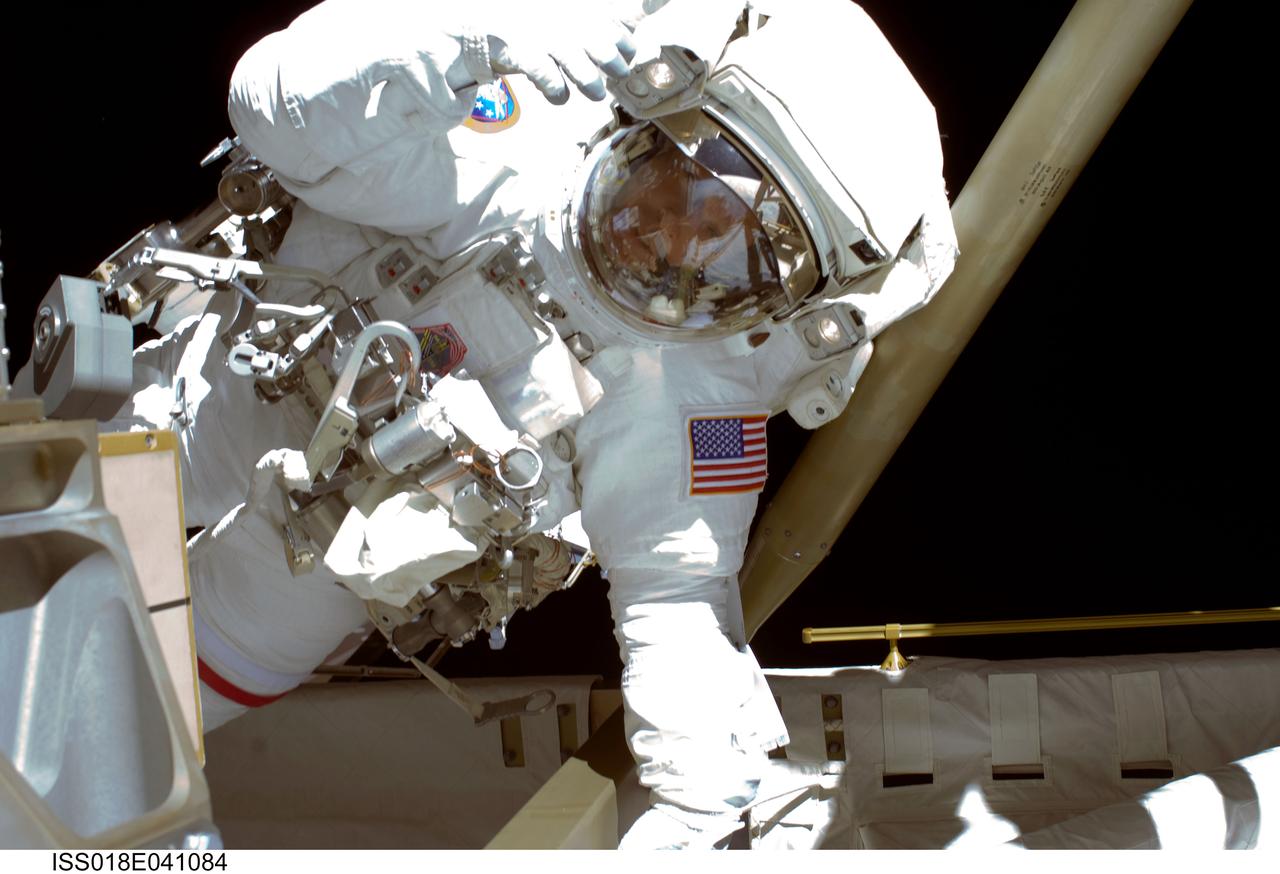 ISS018-E-041084 (19 March 2009) --- Astronaut Steve Swanson, STS-119 mission specialist, participates in the mission's first scheduled session of extravehicular activity (EVA) as construction and maintenance continue on the International Space Station. During the six-hour, seven-minute spacewalk, Swanson and astronaut Richard Arnold (out of frame), mission specialist, connected bolts to permanently attach the S6 truss segment to S5. The spacewalkers plugged in power and data connectors to the truss, prepared a radiator to cool it, opened boxes containing the new solar arrays and deployed the Beta Gimbal Assemblies containing masts that support the solar arrays.