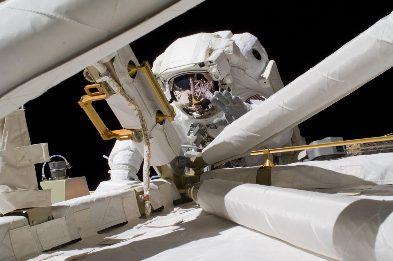 ISS018-E-041089 (19 March 2009) --- Astronaut Richard Arnold, STS-119 mission specialist, participates in the mission's first scheduled session of extravehicular activity (EVA) as construction and maintenance continue on the International Space Station. During the six-hour, seven-minute spacewalk, Arnold and astronaut Steve Swanson (out of frame), mission specialist, connected bolts to permanently attach the S6 truss segment to S5. The spacewalkers plugged in power and data connectors to the truss, prepared a radiator to cool it, opened boxes containing the new solar arrays and deployed the Beta Gimbal Assemblies containing masts that support the solar arrays.