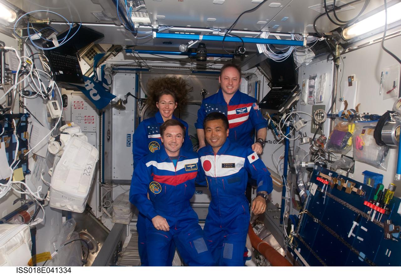 ISS018-E-041334 (20 March 2009) --- Expedition 18 crewmembers pose for a group photo in the Harmony node of the International Space Station while Space Shuttle Discovery (STS-119) remains docked with the station. From the left (front row) are cosmonaut Yury Lonchakov and Japan Aerospace Exploration Agency (JAXA) astronaut Koichi Wakata, both flight engineers. From the left (back row) are NASA astronauts Sandra Magnus, STS-119 mission specialist, and Michael Fincke, commander. Magnus flew to the station on STS-126 to serve as a flight engineer for Expedition 18, and will return to Earth as mission specialist with the STS-119 crew.