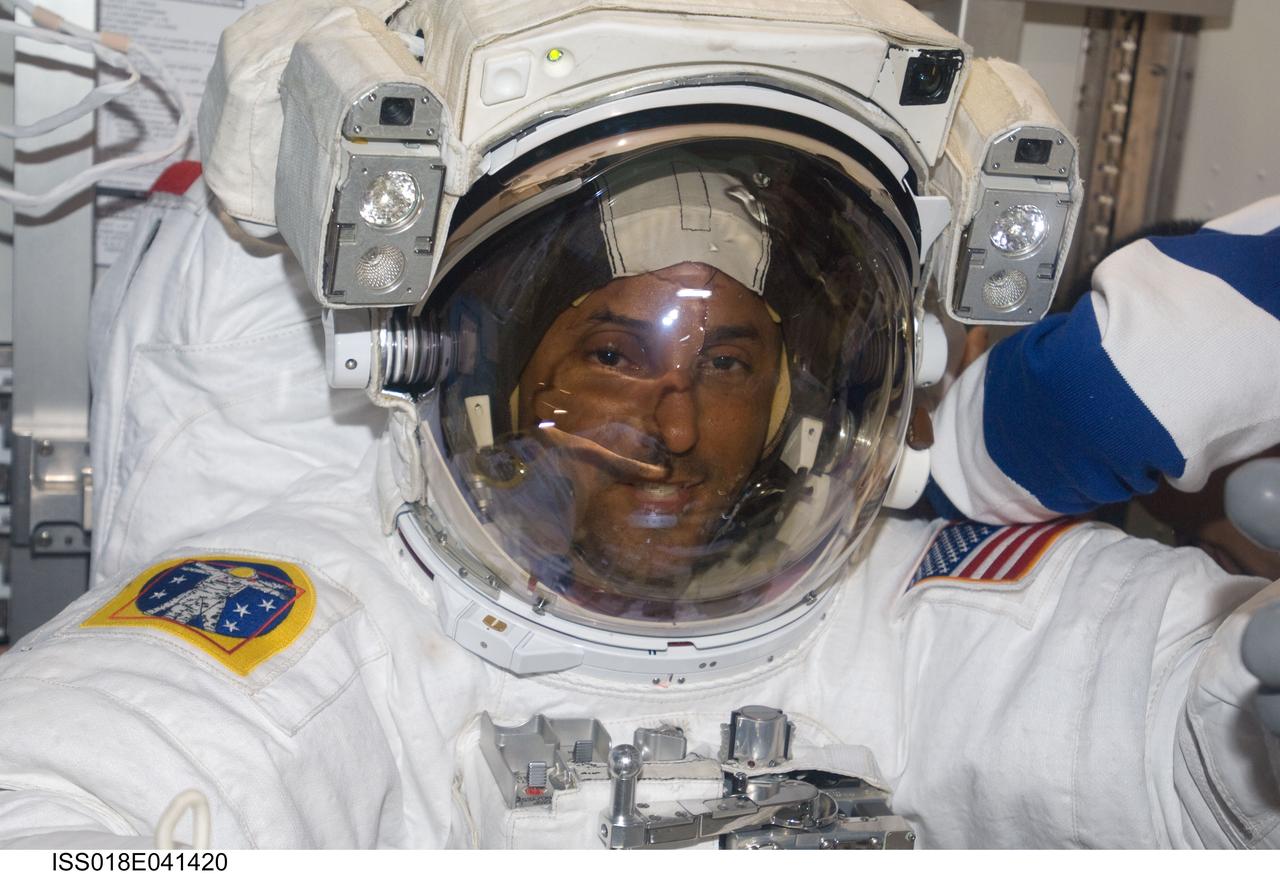 ISS018-E-041420 (21 March 2009) --- Astronaut Joseph Acaba, STS-119 mission specialist, attired in his Extravehicular Mobility Unit (EMU) spacesuit, is pictured in the Quest Airlock of the International Space Station as the mission?s second session of extravehicular activity (EVA) draws to a close.