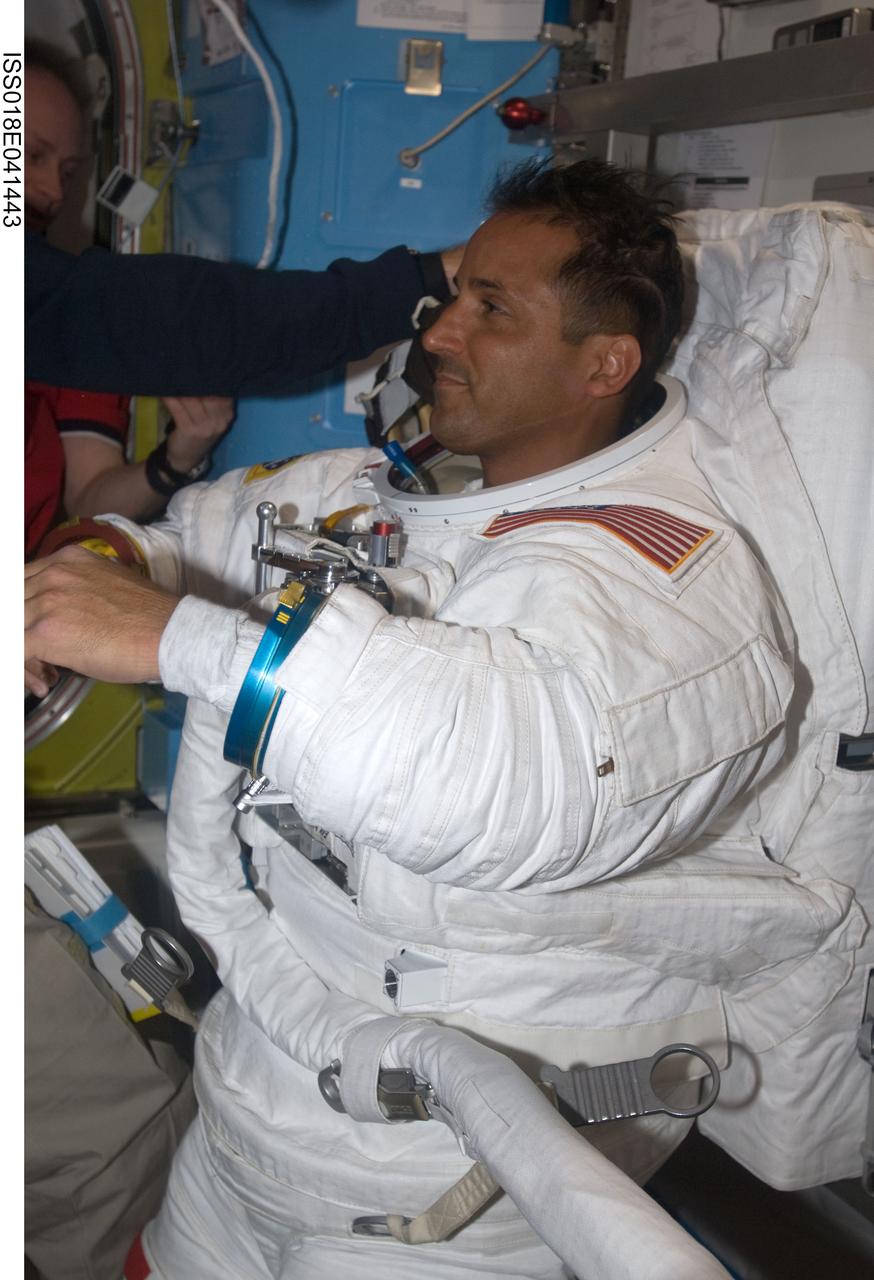 ISS018-E-041443 (21 March 2009) --- Attired in his Extravehicular Mobility Unit (EMU) spacesuit, astronaut Joseph Acaba, STS-119 mission specialist, is pictured in the Quest Airlock of the International Space Station as the mission's second session of extravehicular activity (EVA) draws to a close.