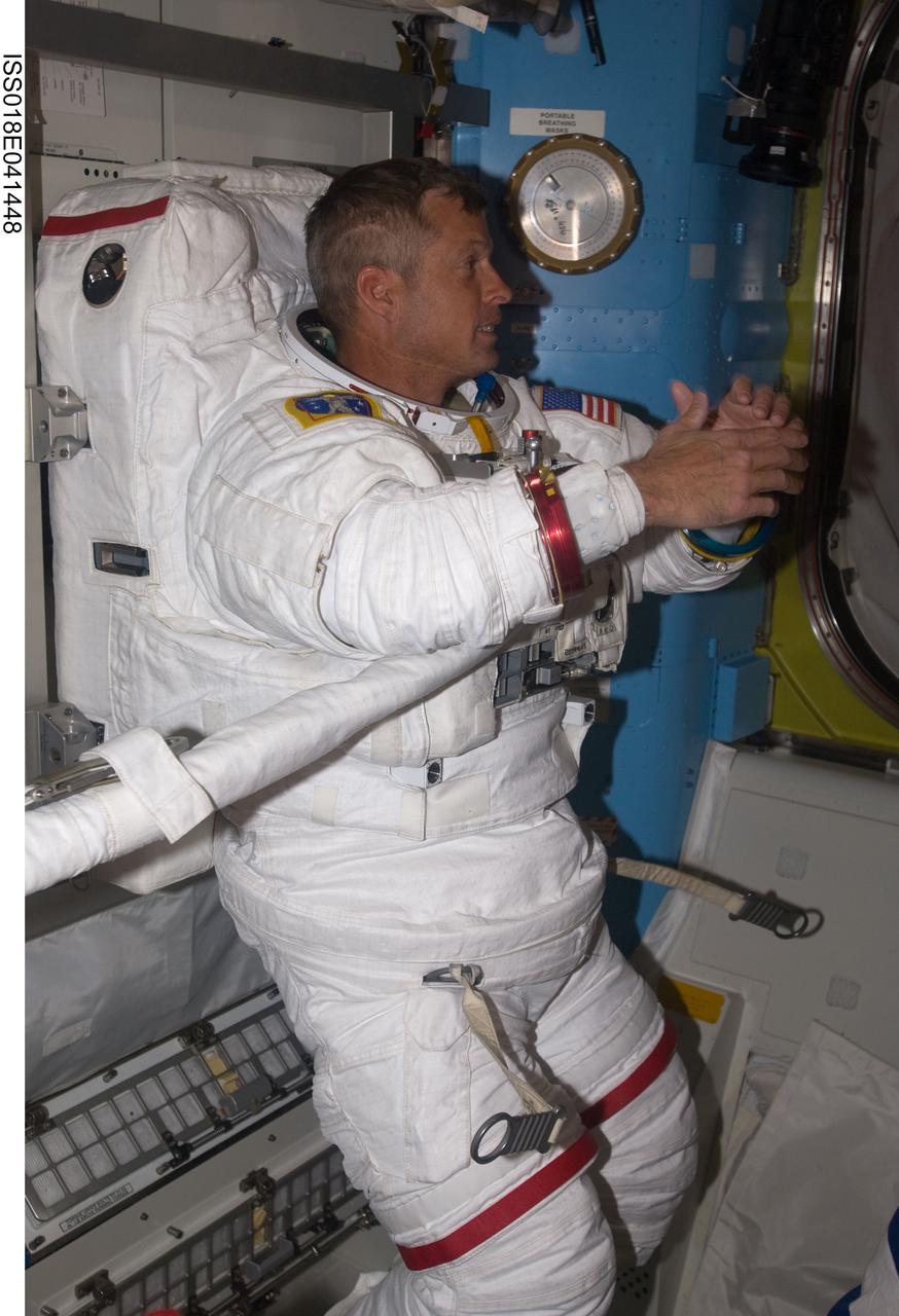 ISS018-E-041448 (21 March 2009) --- Attired in his Extravehicular Mobility Unit (EMU) spacesuit, astronaut Steve Swanson, STS-119 mission specialist, is pictured in the Quest Airlock of the International Space Station as the mission's second session of extravehicular activity (EVA) draws to a close.