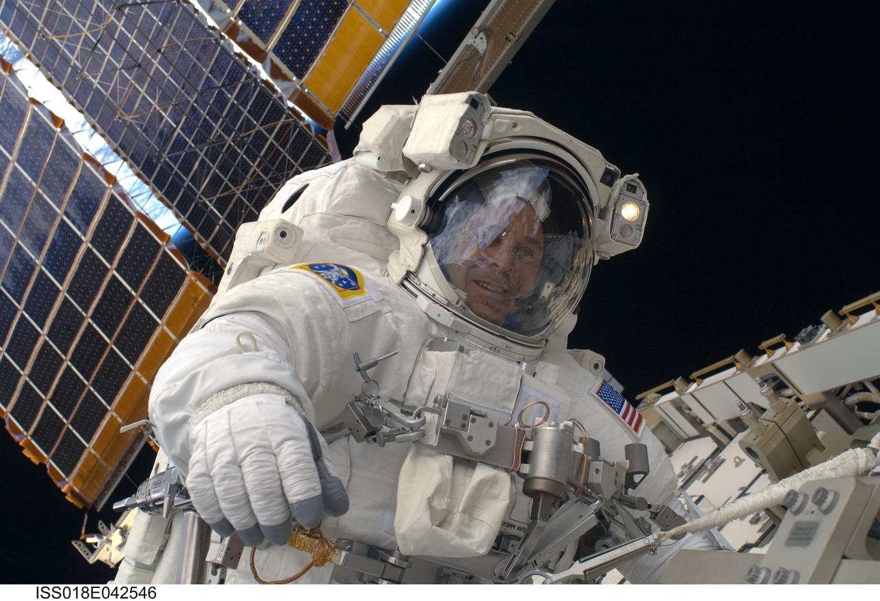 ISS018-E-042546 (23 March 2009) --- Astronaut Richard Arnold, STS-119 mission specialist, participates in the mission's third scheduled session of extravehicular activity (EVA) as construction and maintenance continue on the International Space Station. During the six-hour, 27-minute spacewalk, Arnold and Joseph Acaba (out of frame), mission specialist, helped robotic arm operators relocate the Crew Equipment Translation Aid (CETA) cart from the Port 1 to Starboard 1 truss segment, installed a new coupler on the CETA cart, lubricated snares on the "B" end of the space station's robotic arm and performed a few "get ahead" tasks.