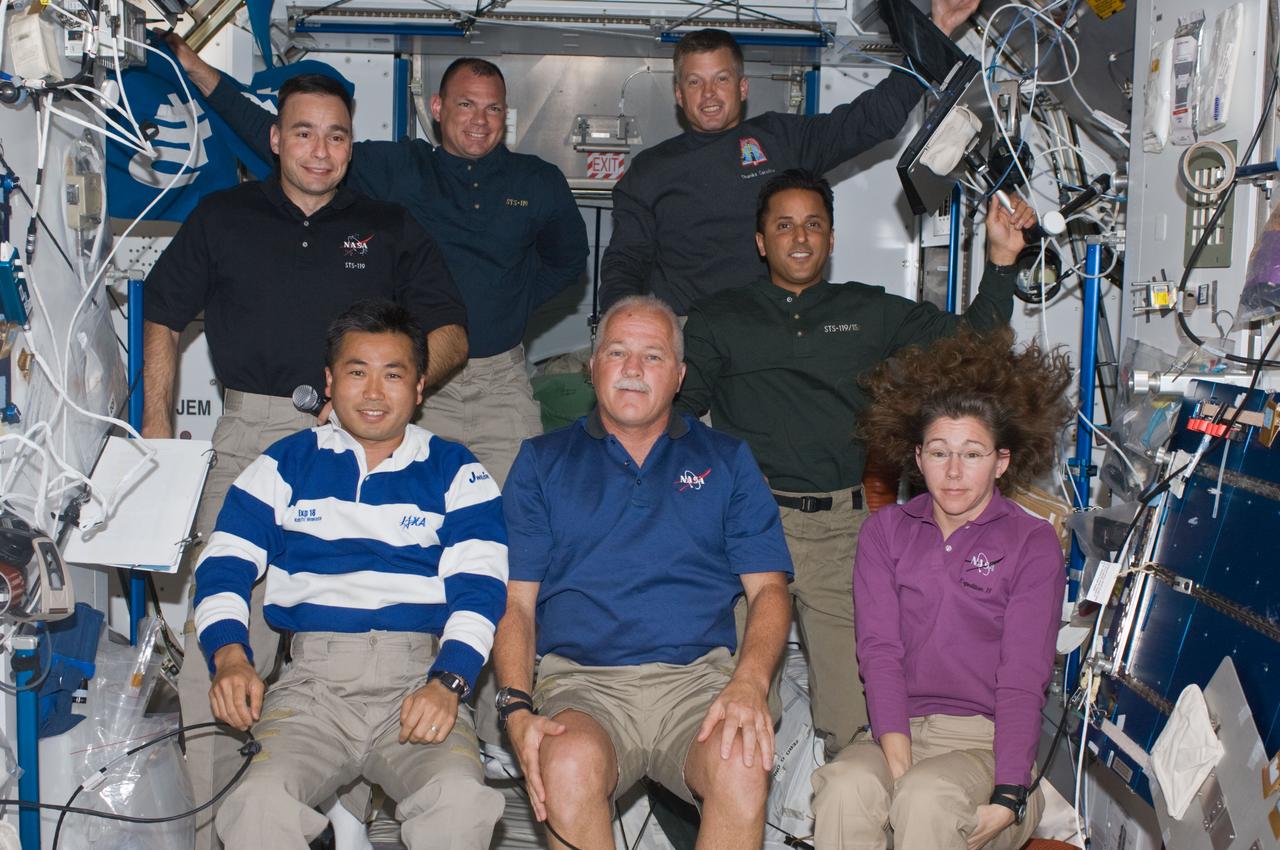 ISS018-E-042673 (22 March 2009) --- Seven of the ten crewmembers on the International Space Station are pictured in the Harmony node while Space Shuttle Discovery remains docked with the station. Pictured from the left (bottom) are Japan Aerospace Exploration Agency (JAXA) astronaut Koichi Wakata, Expedition 18 flight engineer; NASA astronauts John Phillips and Sandra Magnus, both STS-119 mission specialists. From the left (top) are astronauts Lee Archambault, STS-119 commander; Tony Antonelli, STS-119 pilot; Steve Swanson and Joseph Acaba, both STS-119 mission specialists.