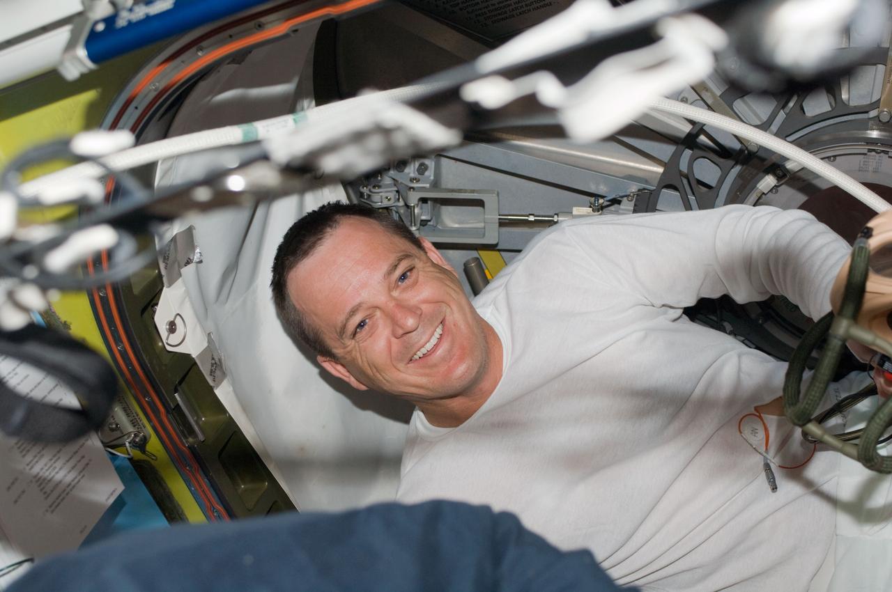 ISS018-E-042690 (23 March 2009) --- Astronaut Richard Arnold, STS-119 mission specialist, is pictured in the Quest Airlock of the International Space Station while Space Shuttle Discovery remains docked with the station.
