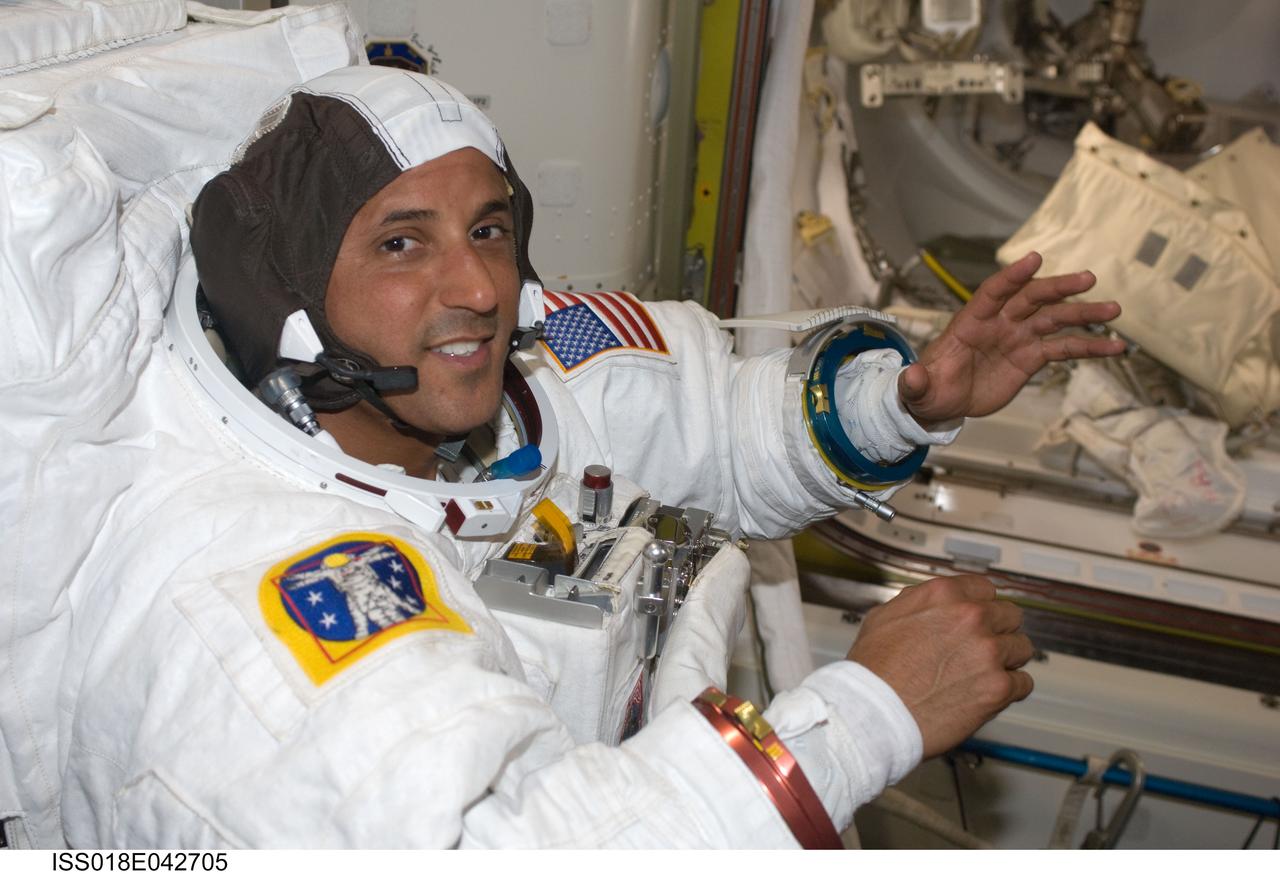 ISS018-E-042705 (23 March 2009) --- Astronaut Joseph Acaba, STS-119 mission specialist, attired in his Extravehicular Mobility Unit (EMU) spacesuit, is pictured in the Quest Airlock of the International Space Station as he prepares for the mission's third scheduled session of extravehicular activity (EVA).